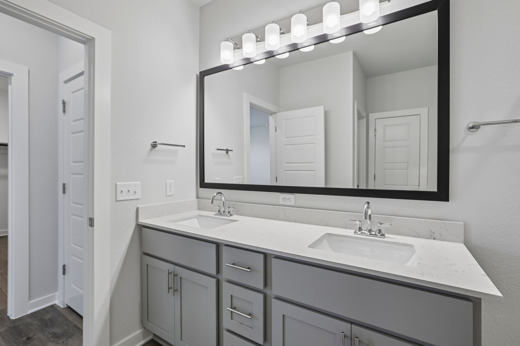 A bathroom with a large mirror.