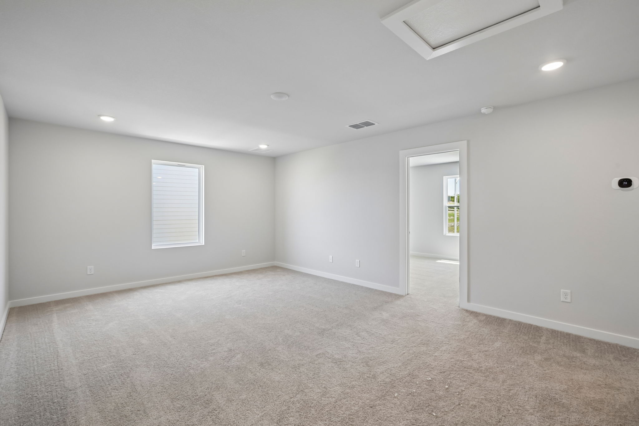 A room with a carpet and a door.
