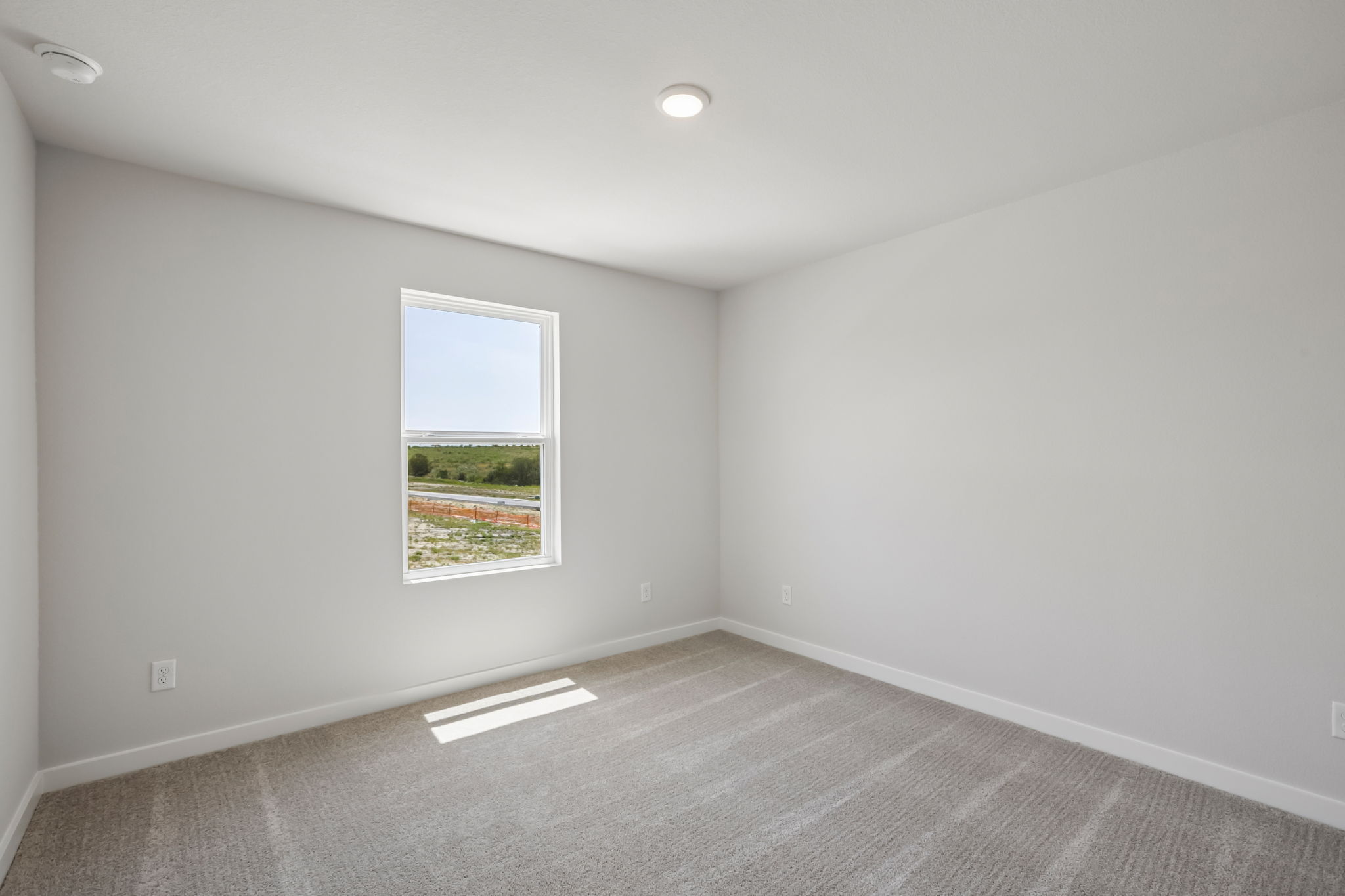 A room with a window and a vent.