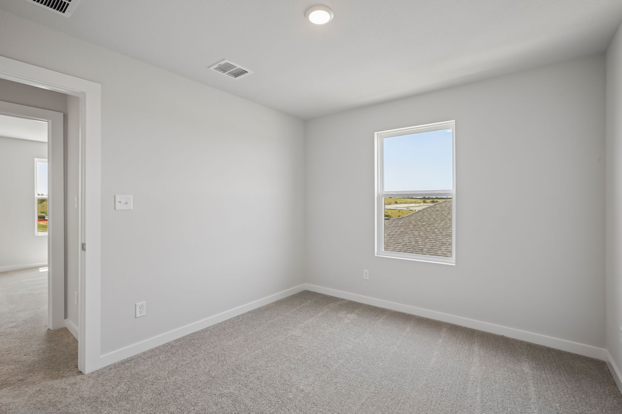 A room with a window and a door.