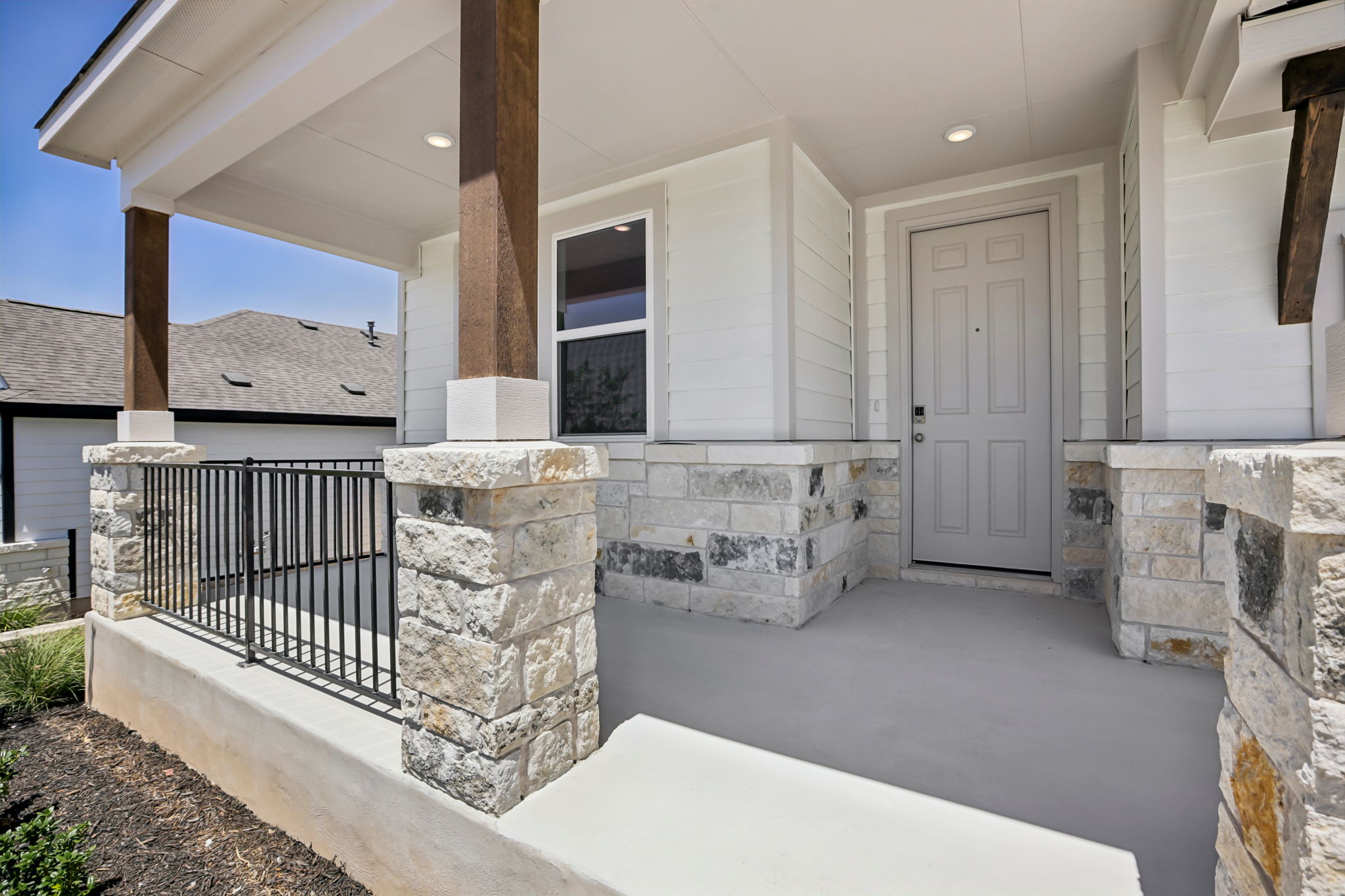 A house with a stone patio.