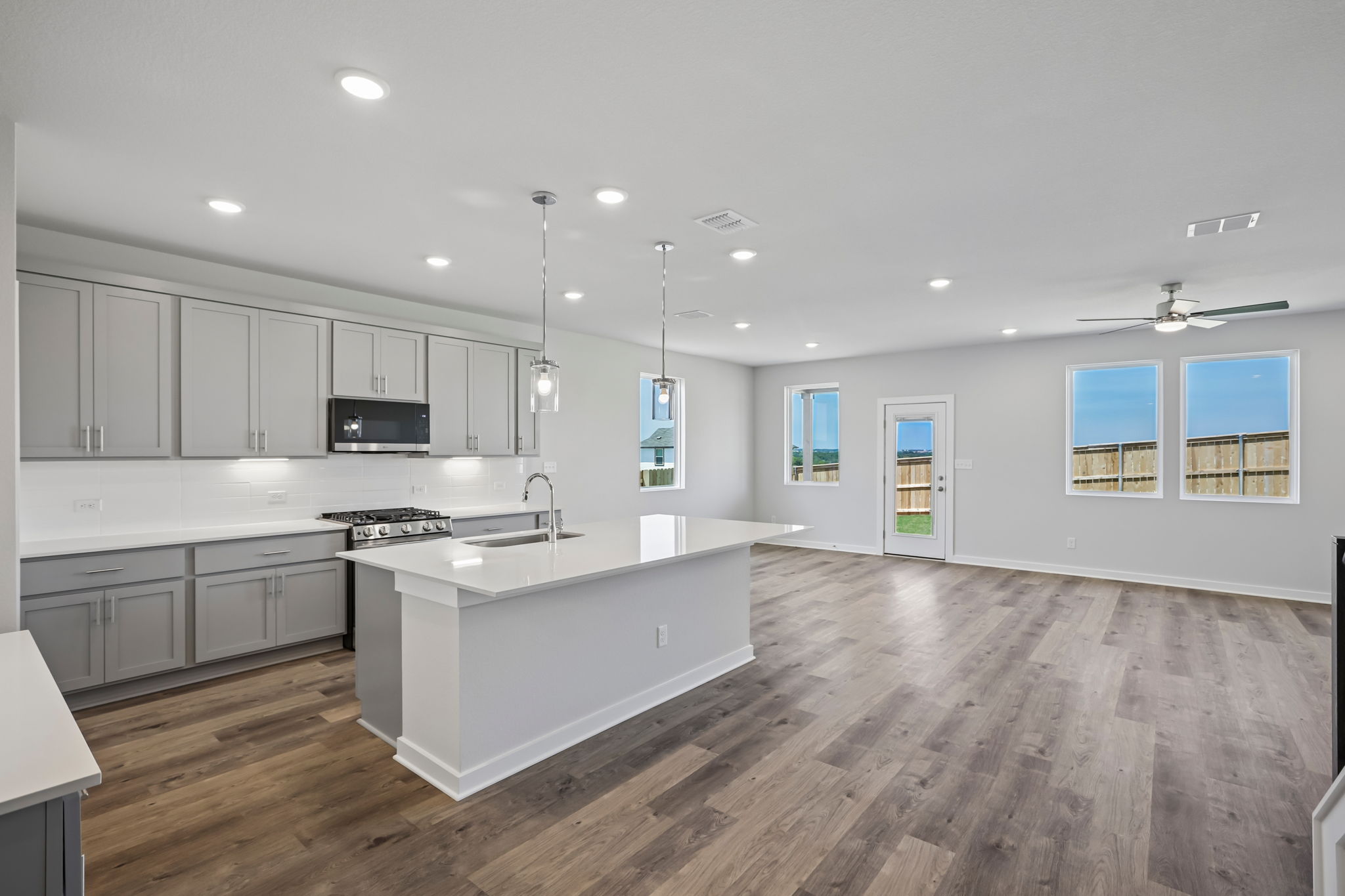 A kitchen with white cabinets.