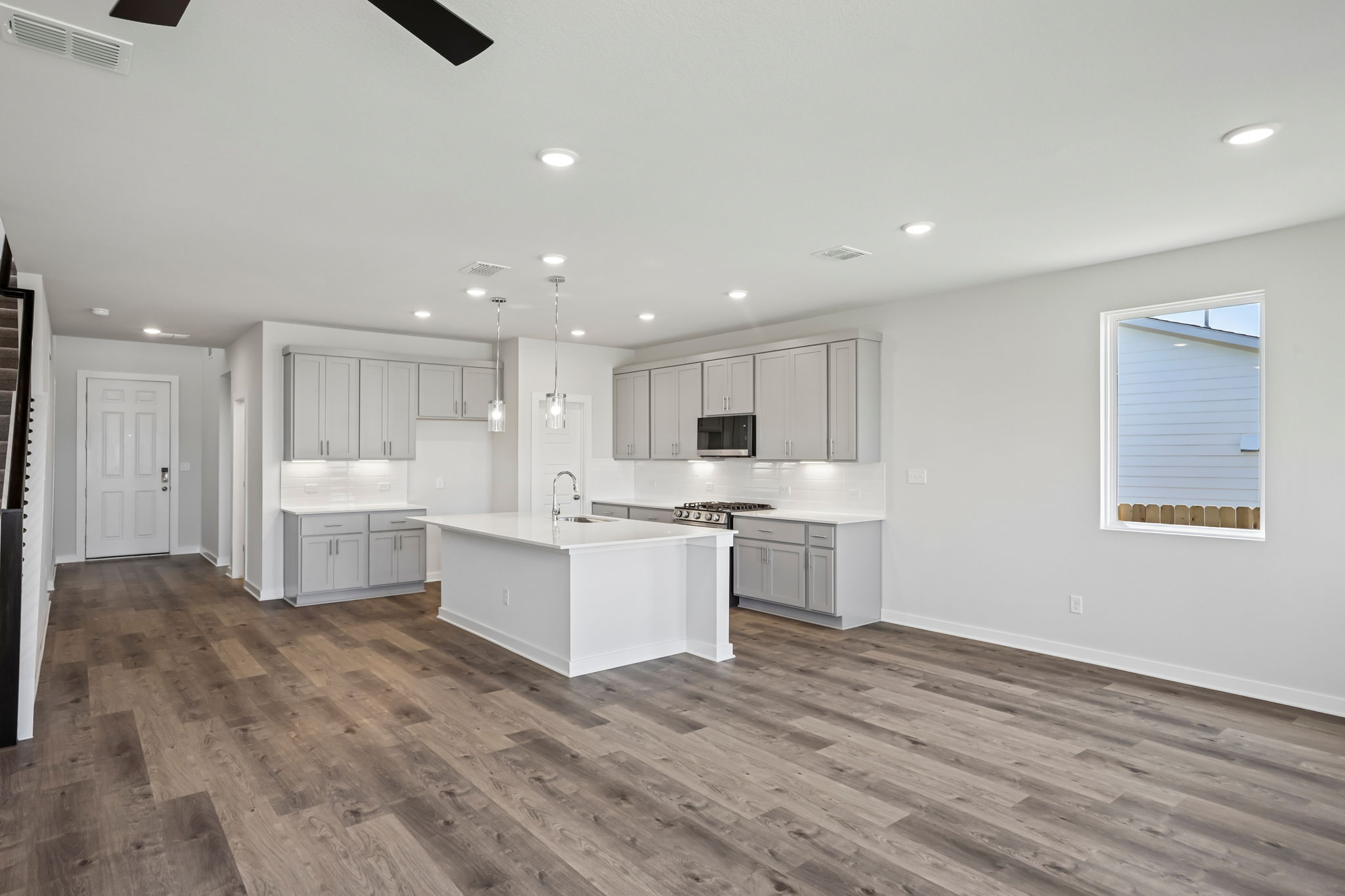 A kitchen with white cabinets.