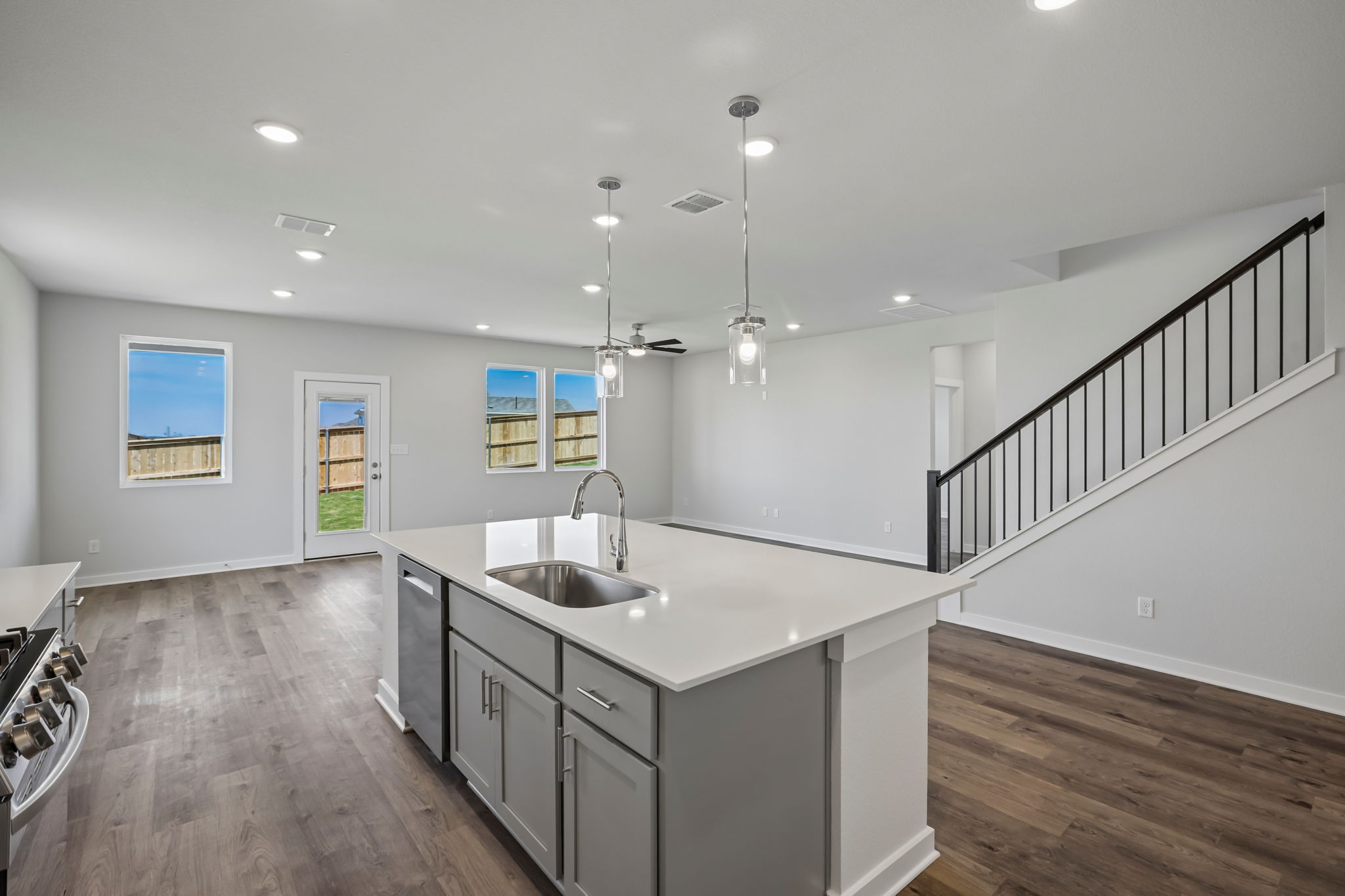 A kitchen with a wood floor.