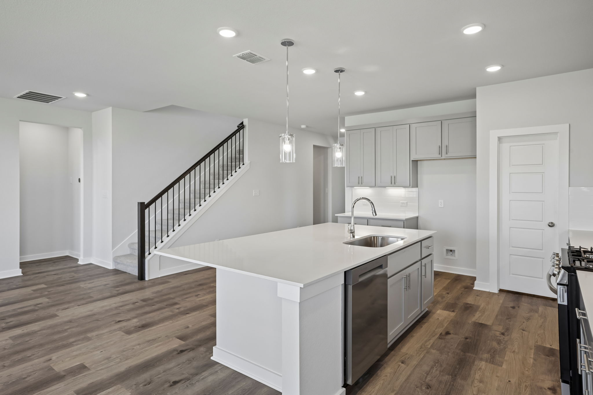 A kitchen with white cabinets.