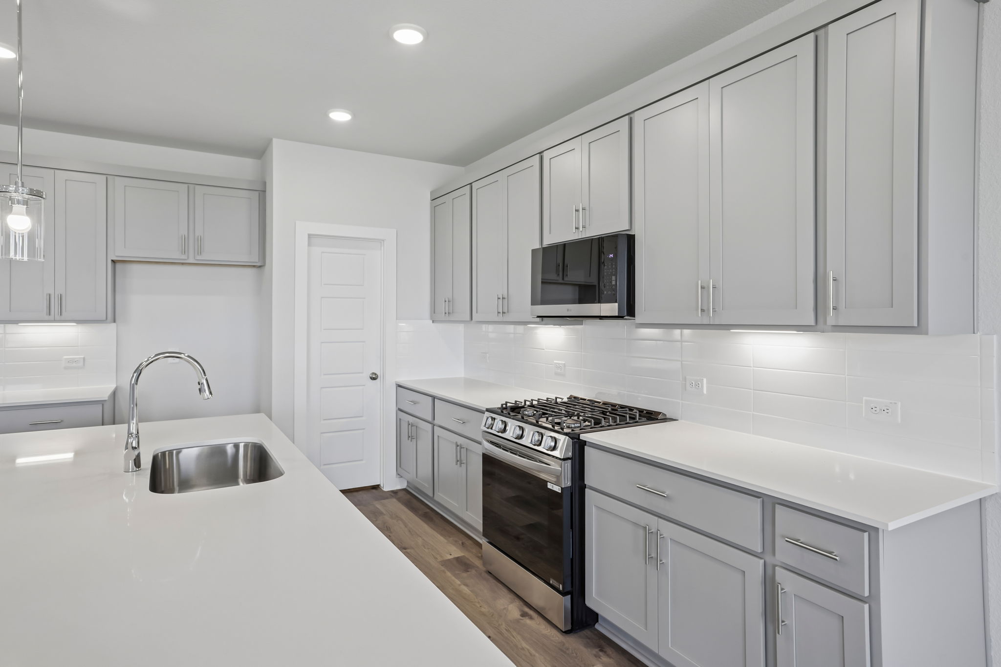 A kitchen with white cabinets.