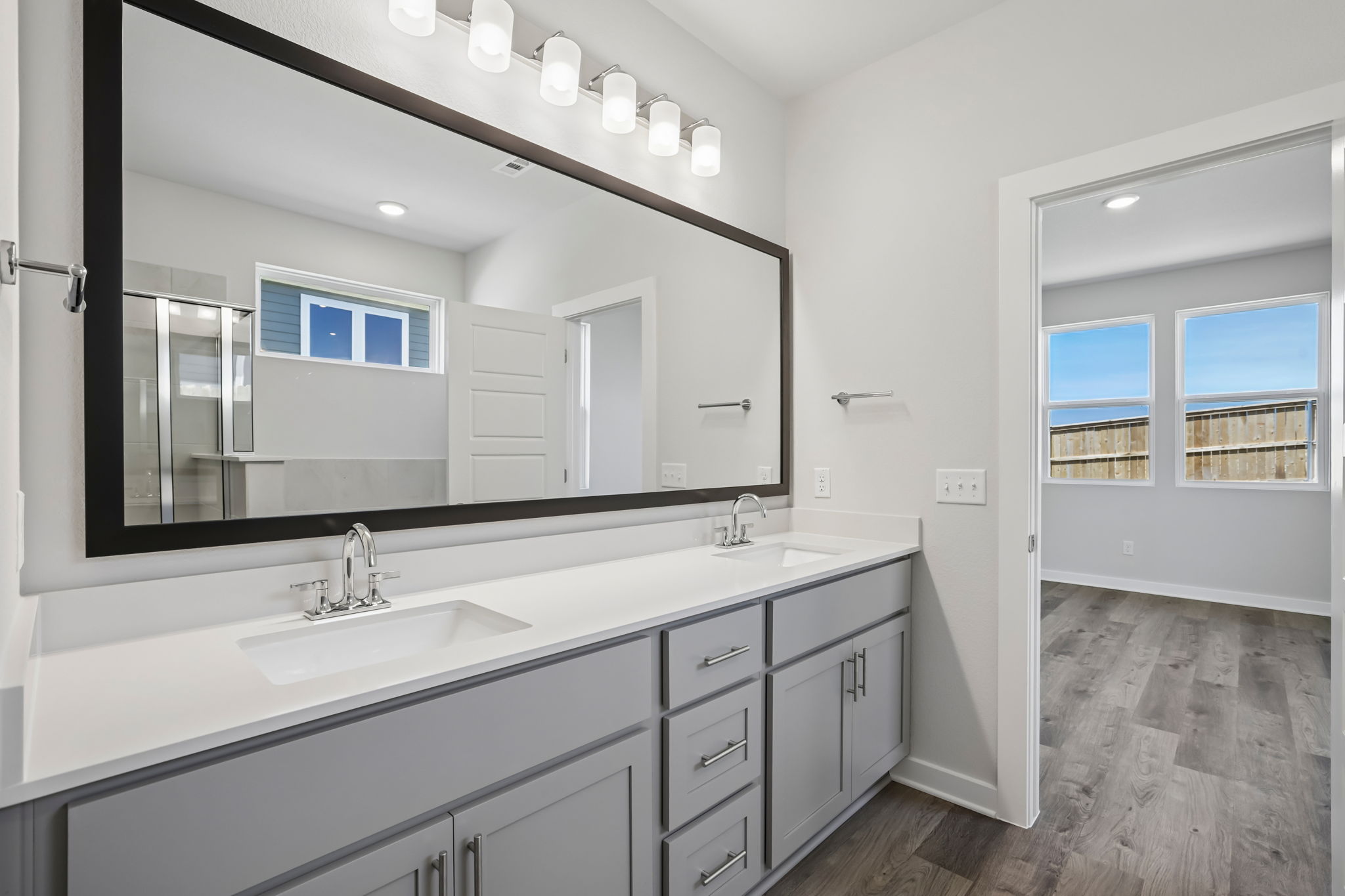 A bathroom with a large mirror.