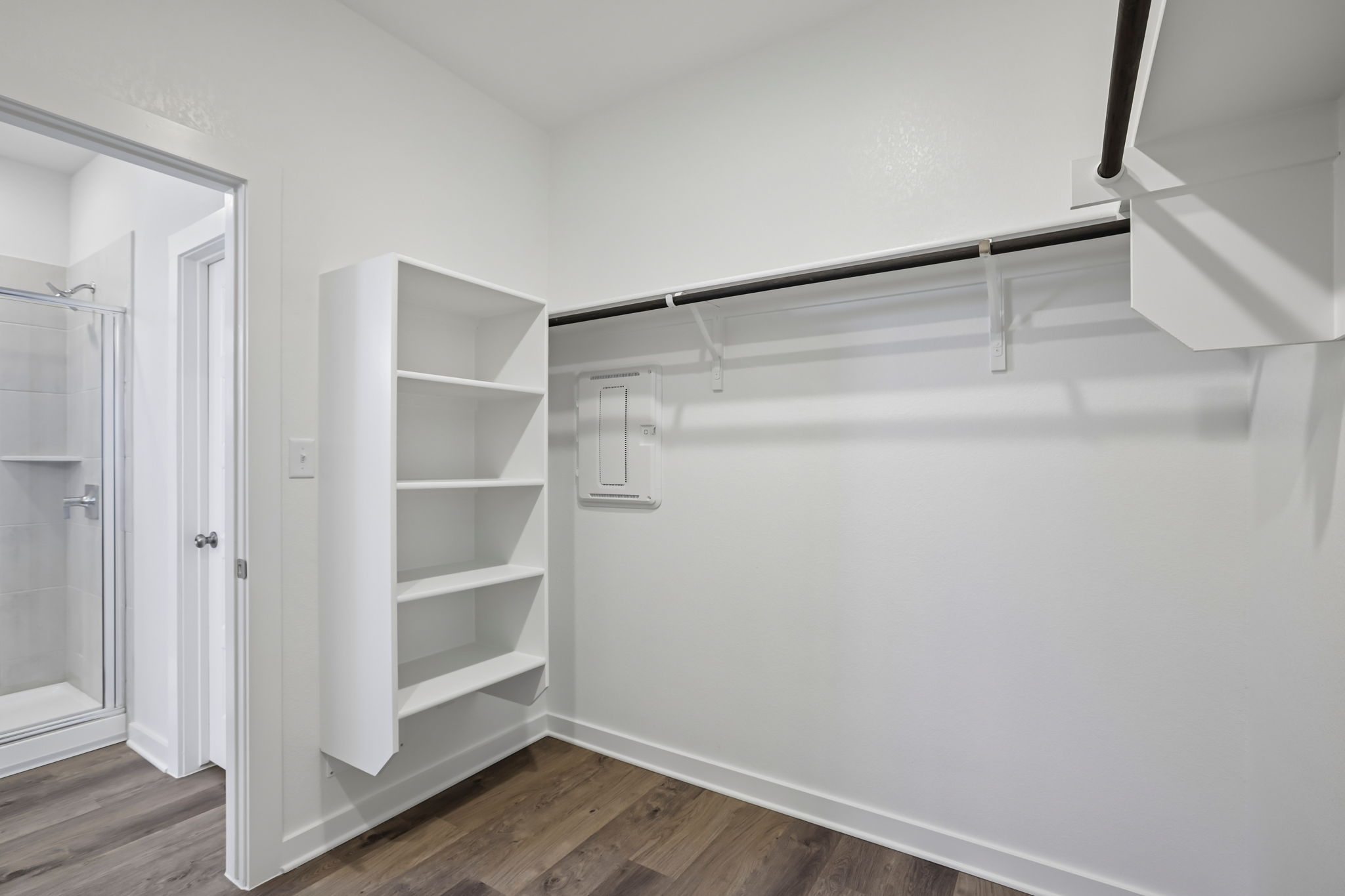 A white room with a glass door.
