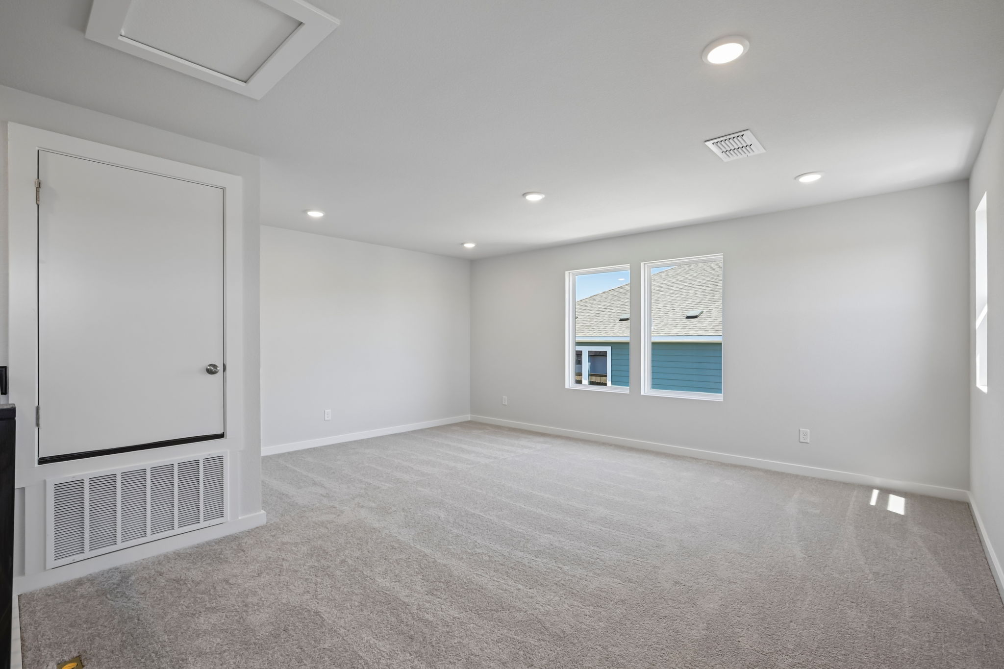 A room with a white door and a window.