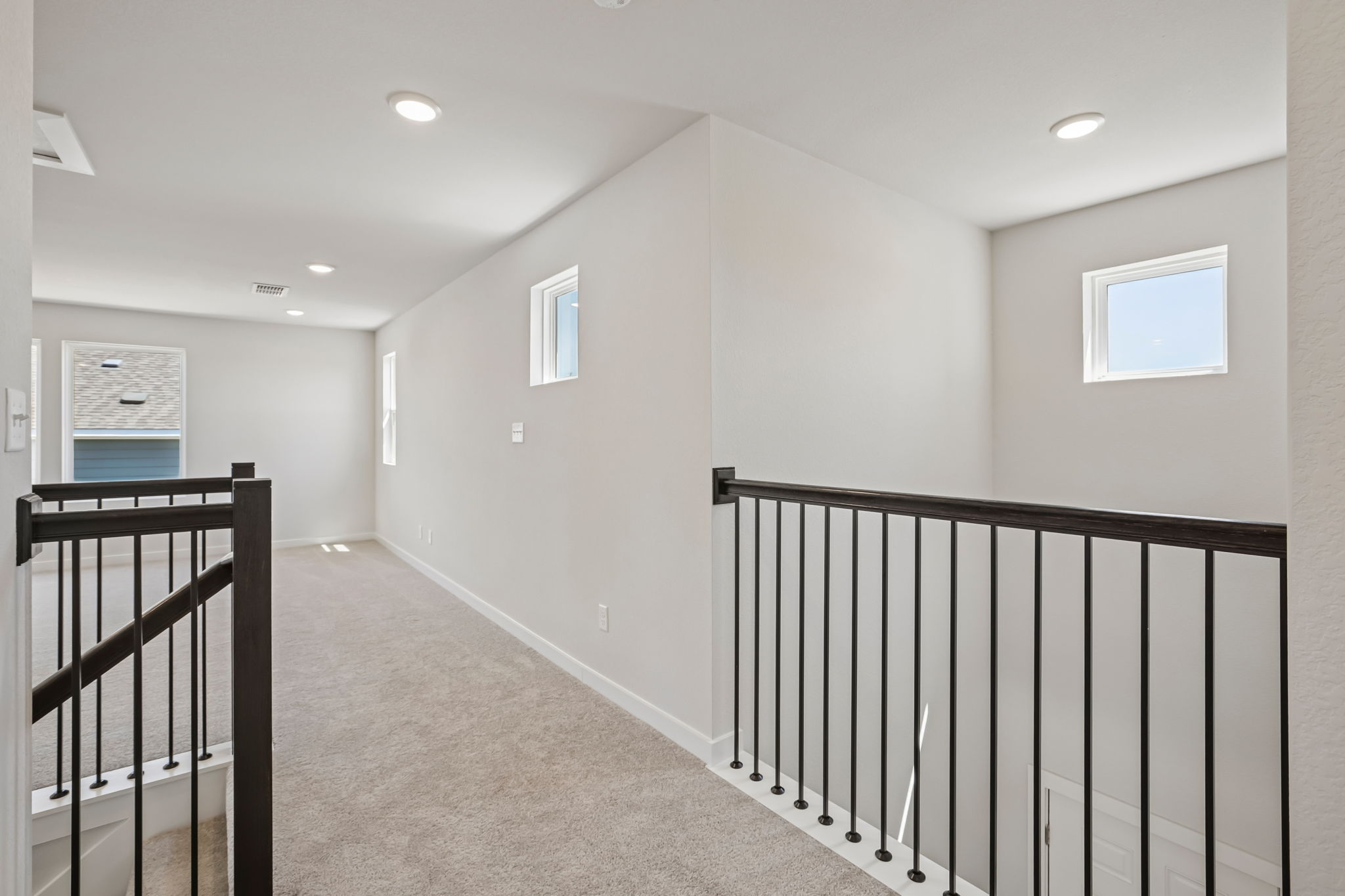 A hallway with a railing.