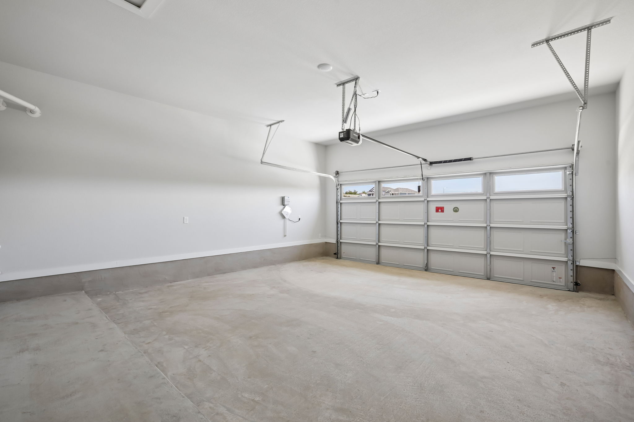 A large white room with a metal gate.
