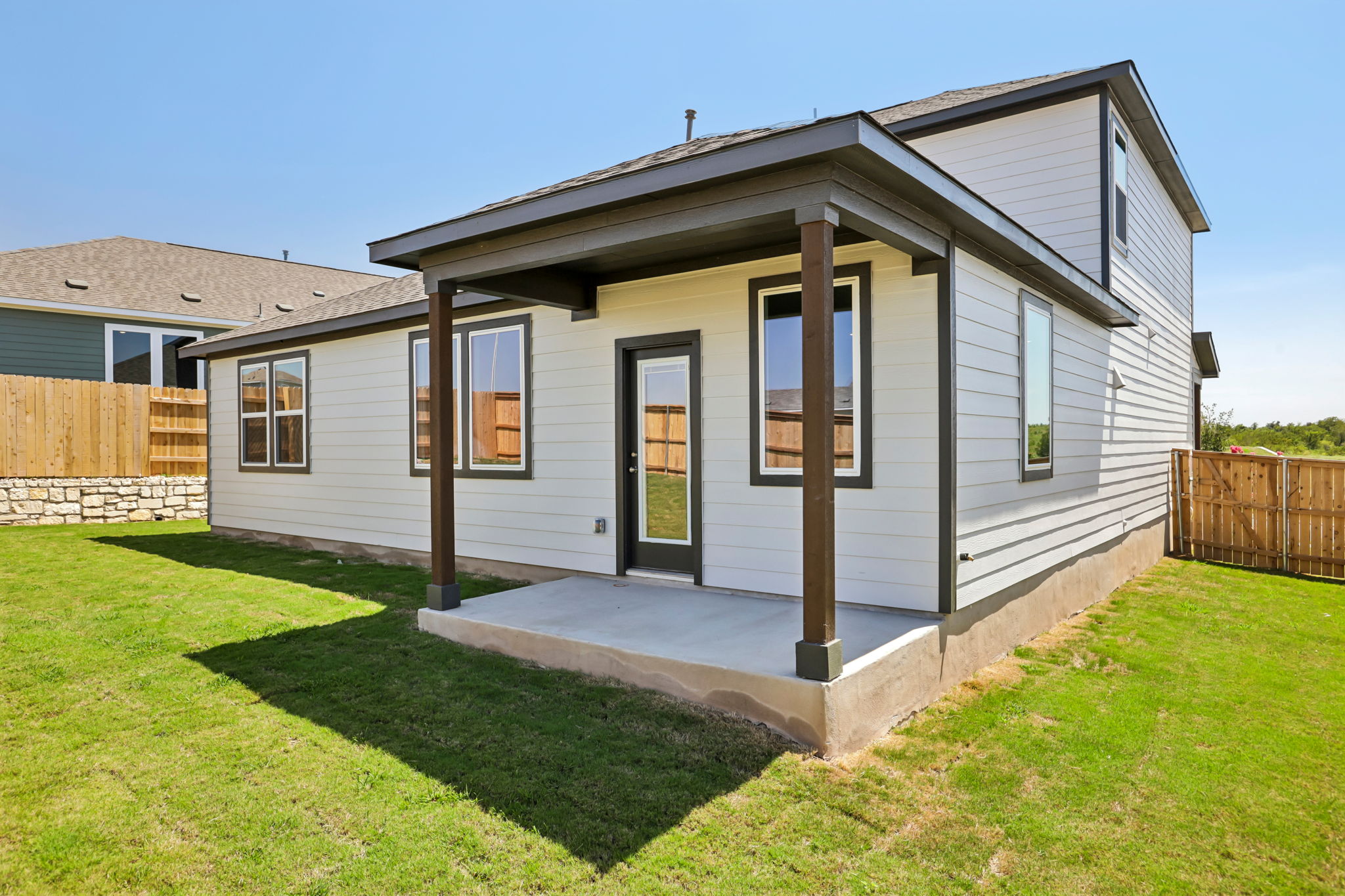 A house with a fence and grass.