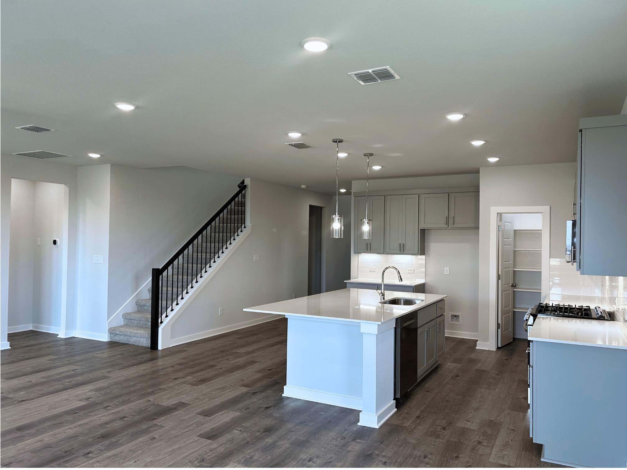A kitchen with a wood floor.