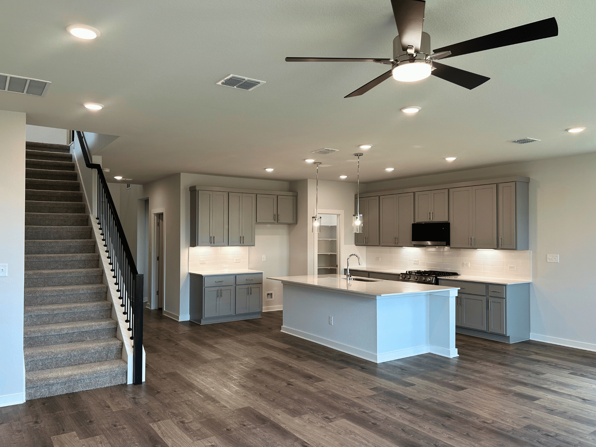 A kitchen with a wood floor.