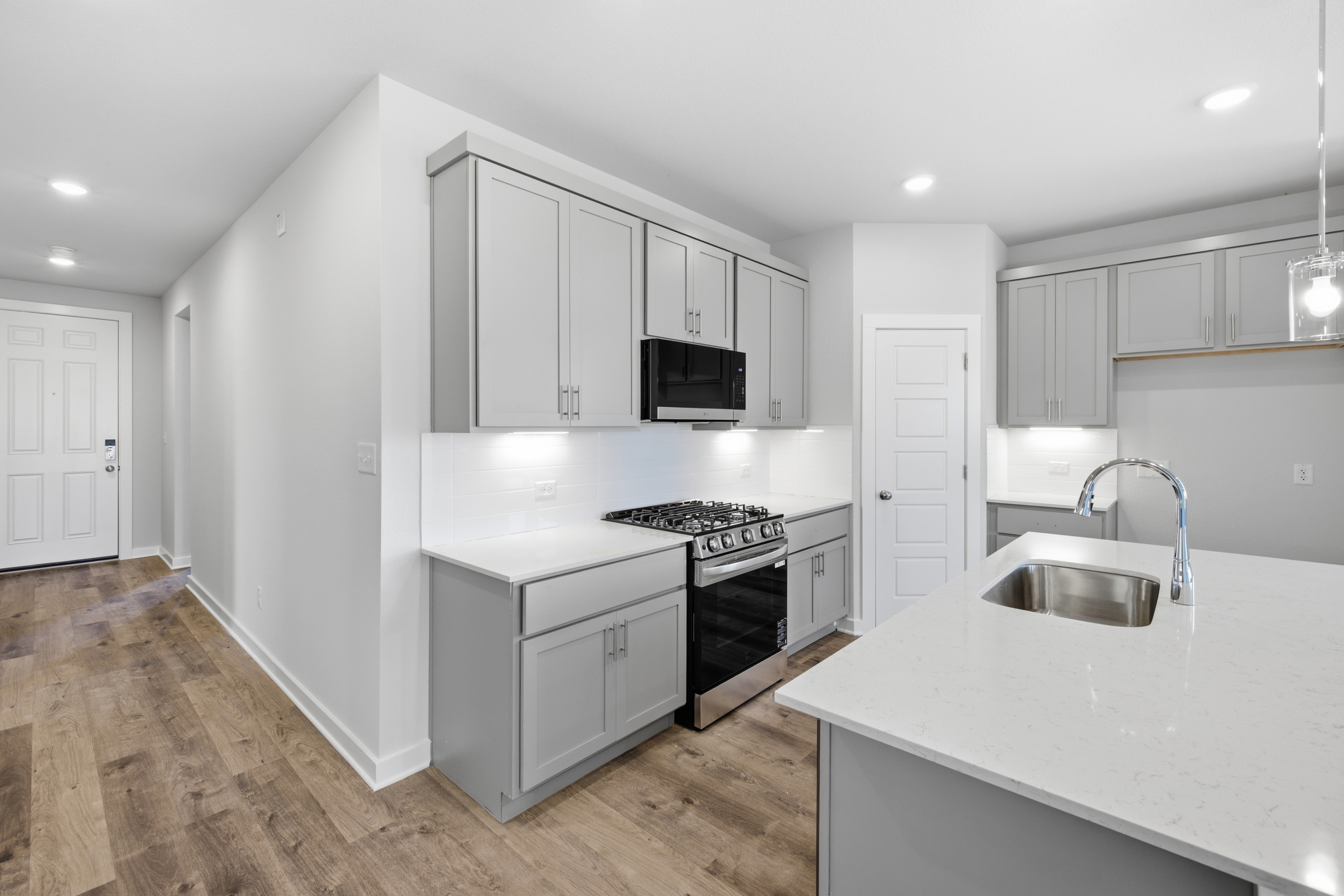 A kitchen with white cabinets.