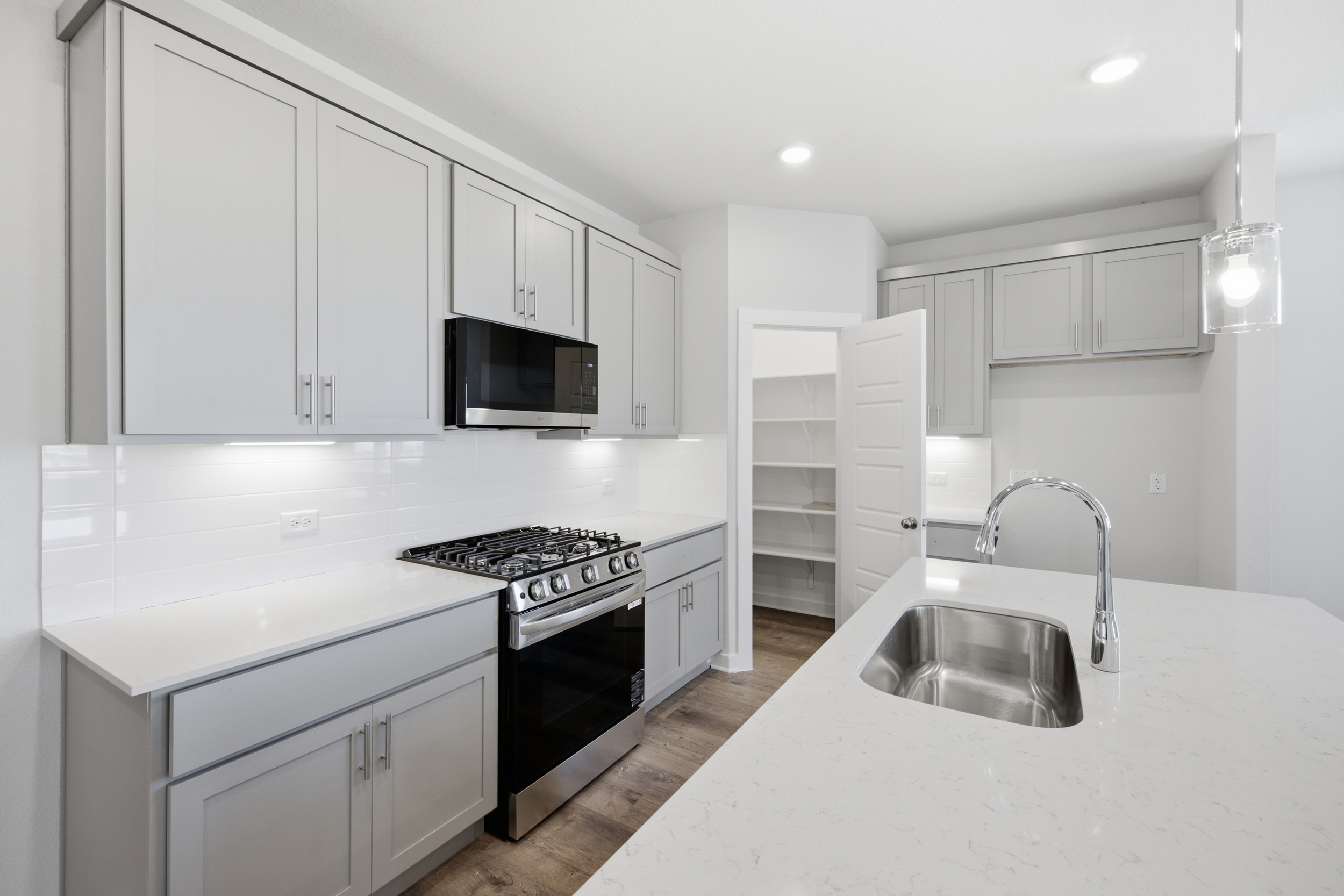 A kitchen with white cabinets.