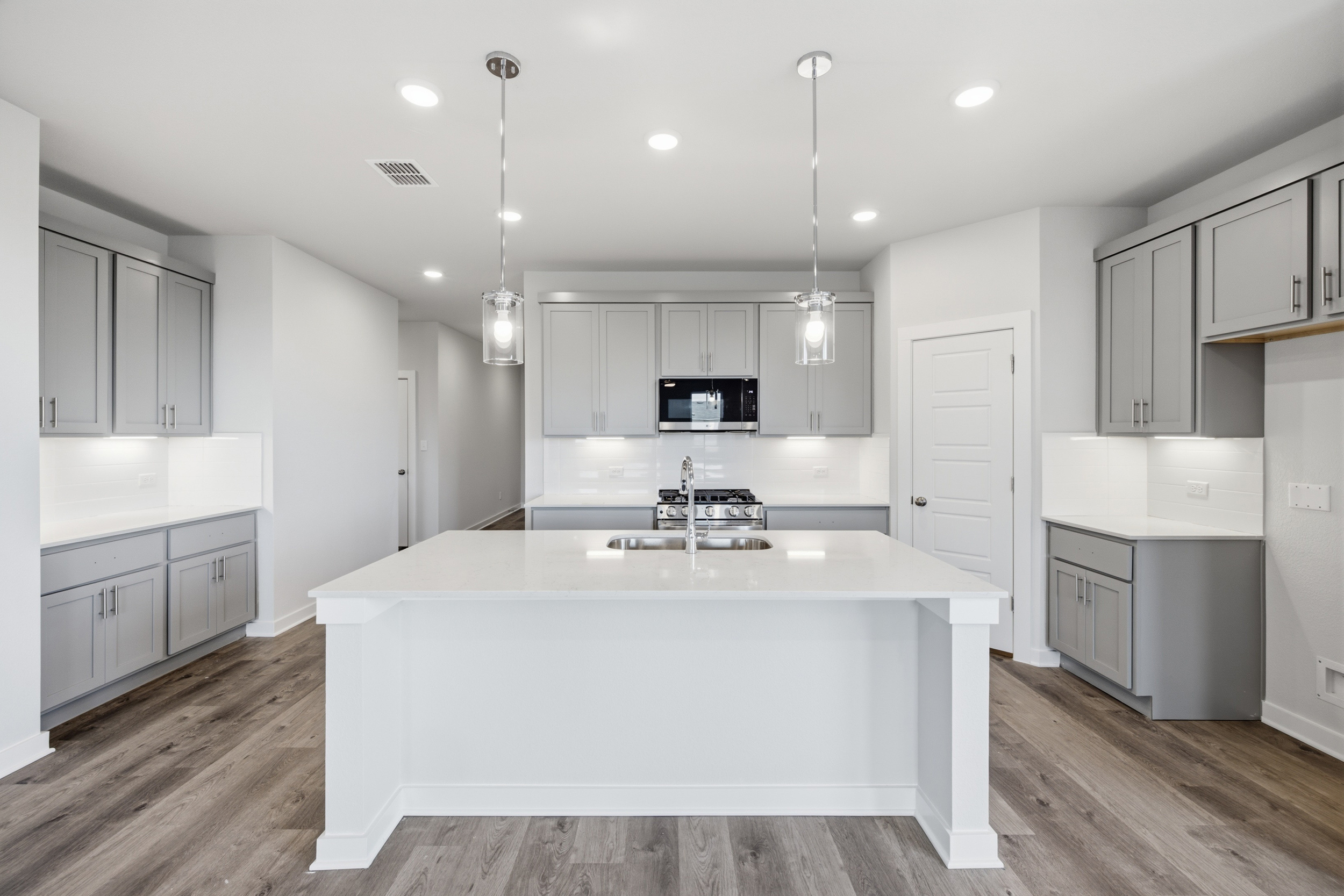 A kitchen with white cabinets.