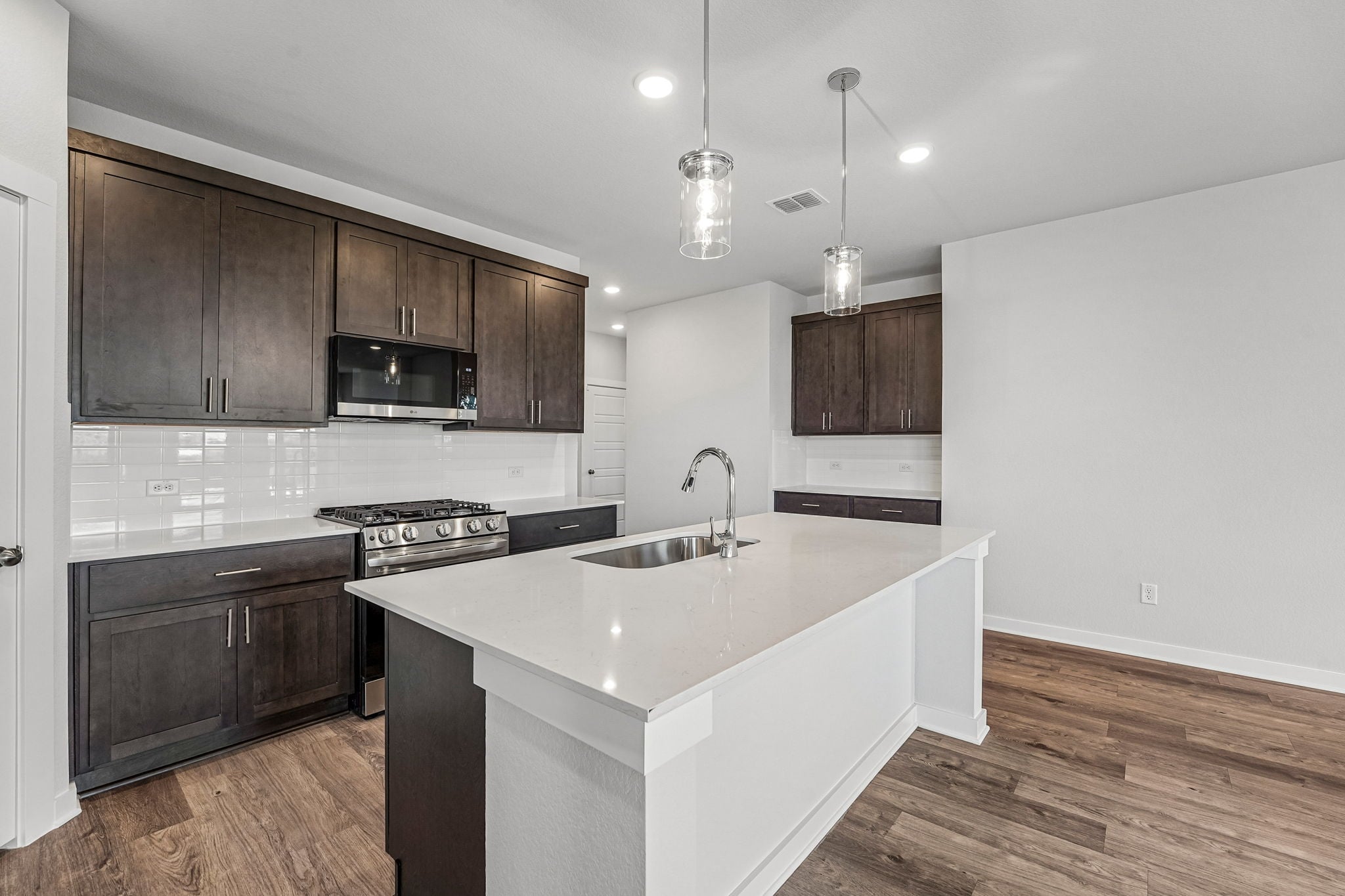 A kitchen with a sink and a stove.