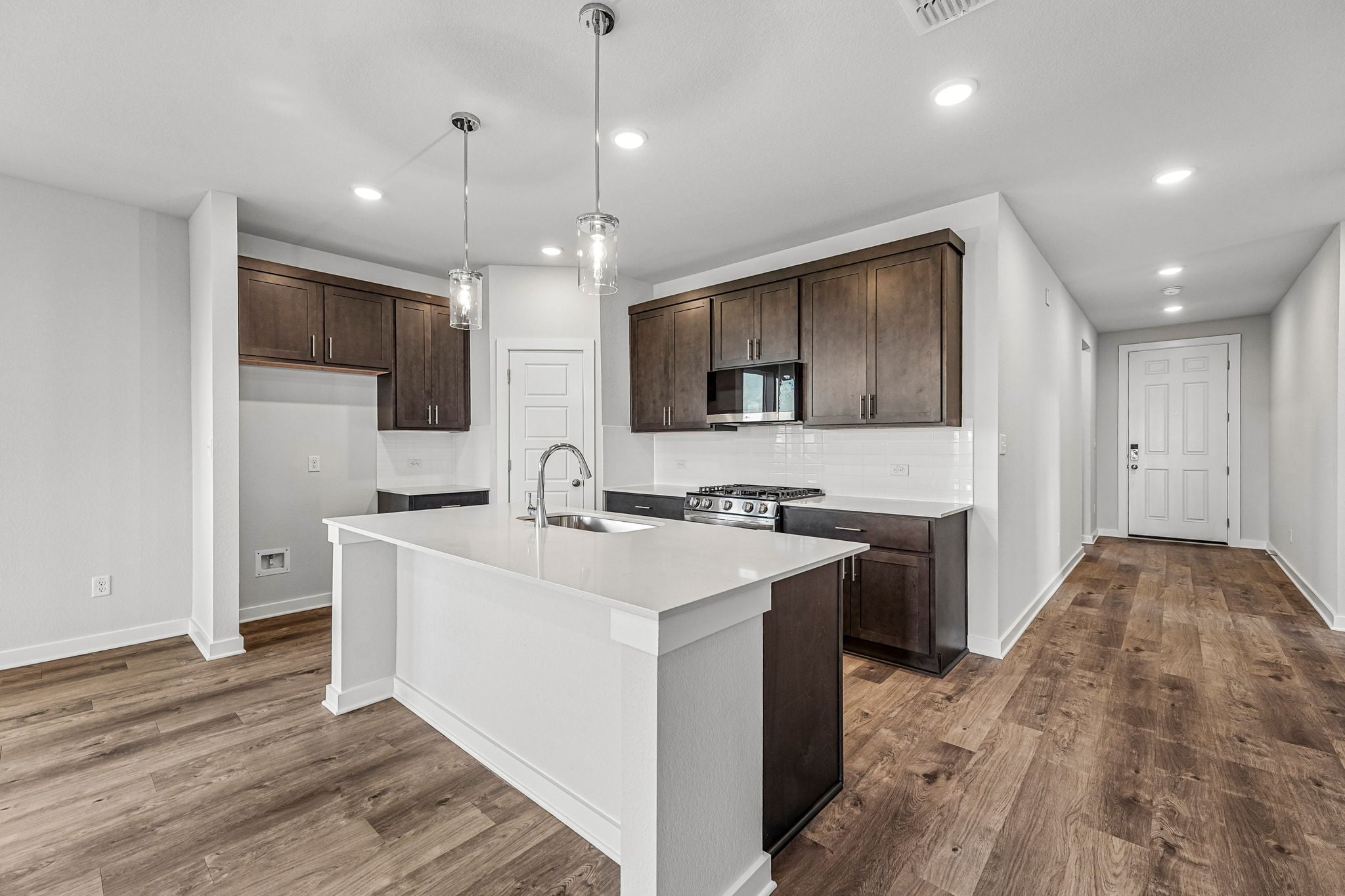 A kitchen with wooden cabinets.