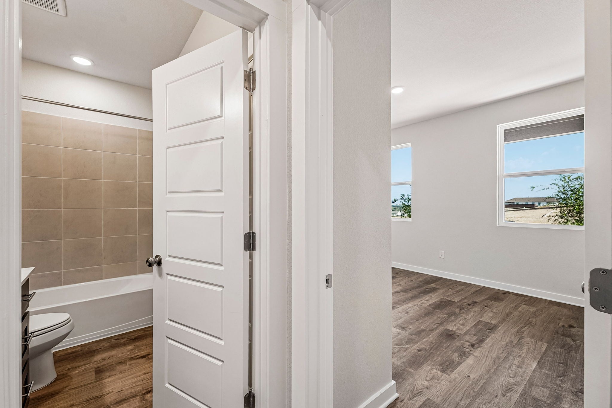 A bathroom with a tub and toilet.