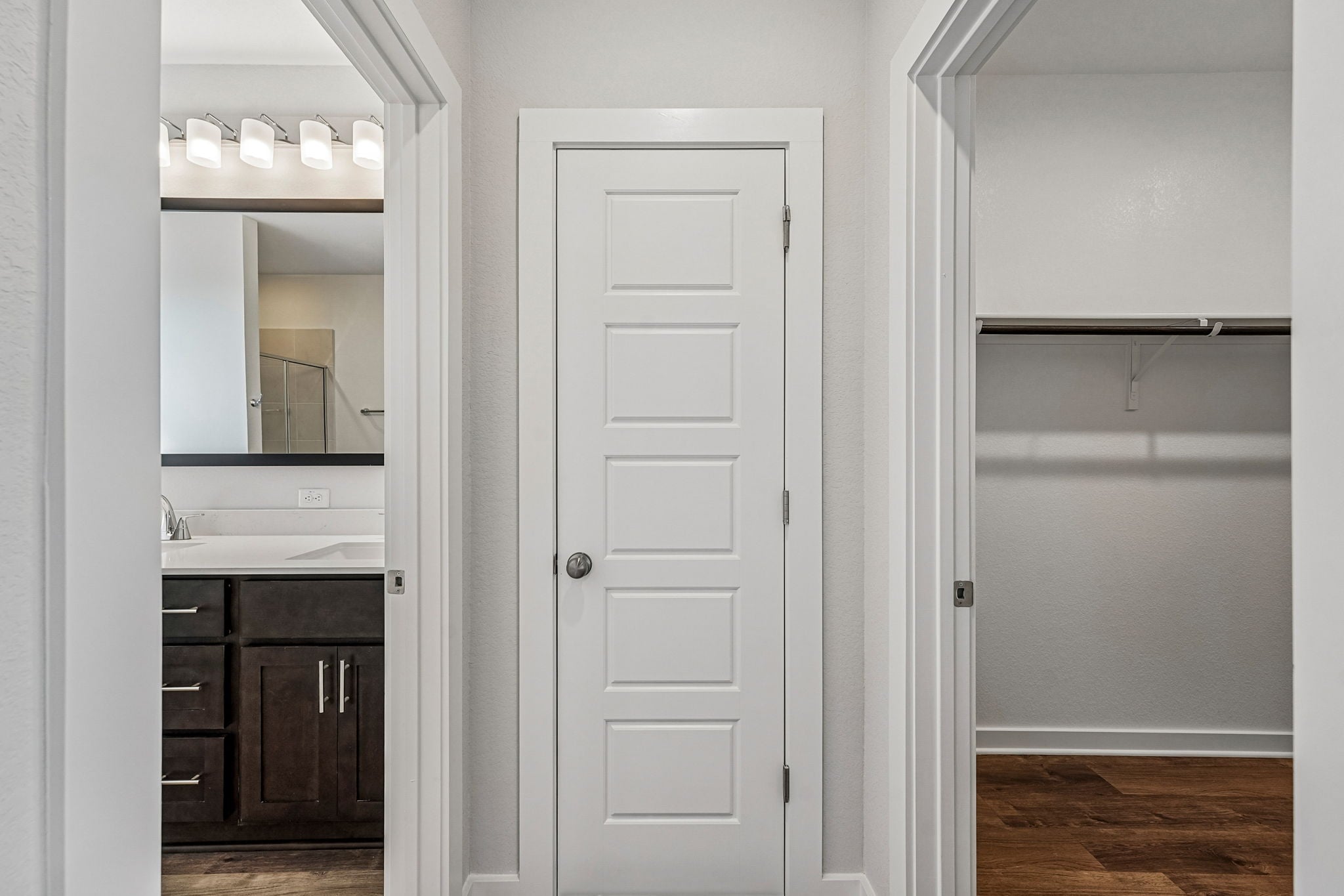 A bathroom with a white door.