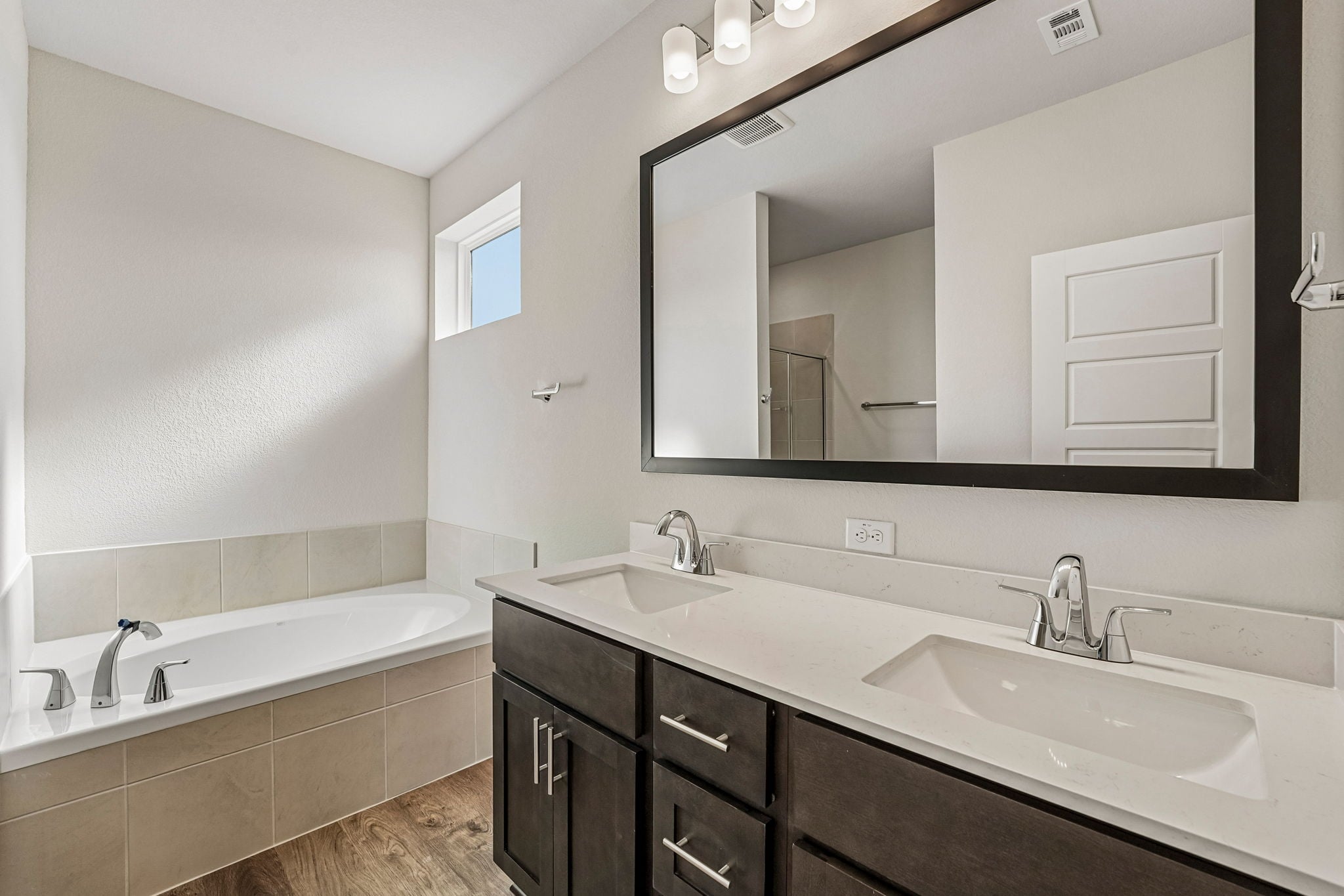 A bathroom with a large mirror.