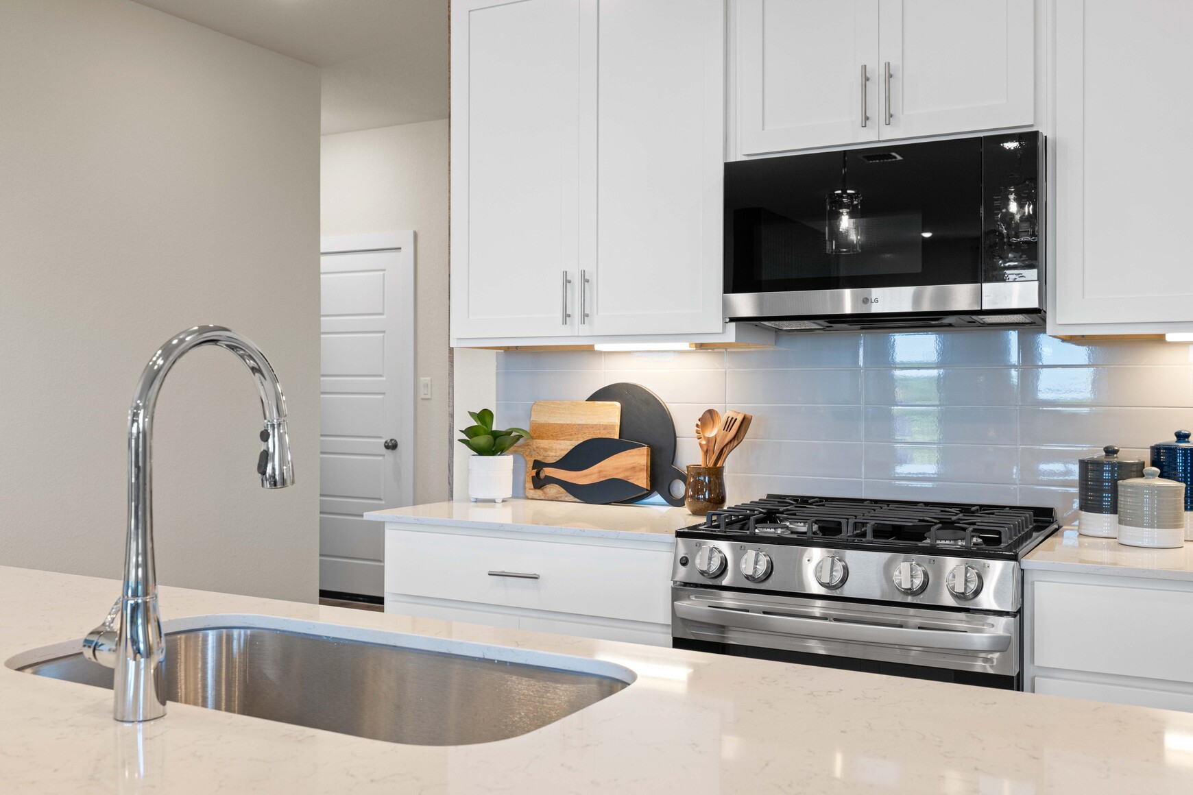 A kitchen with white cabinets.