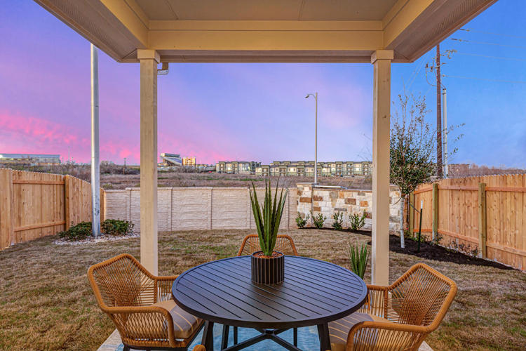 A table and chairs on a deck.