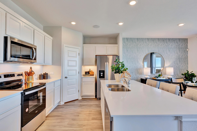 A kitchen with white cabinets.