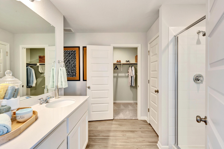 A bathroom with a sink and a shower.