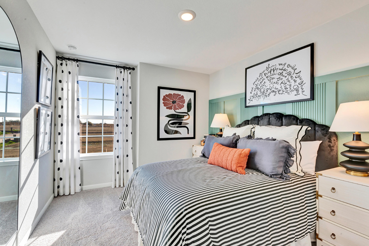 A bedroom with a bed and a window.