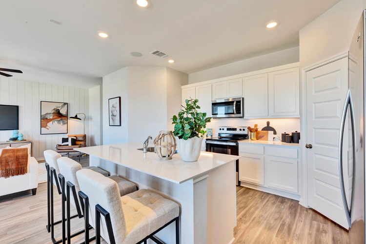 A kitchen with white cabinets.