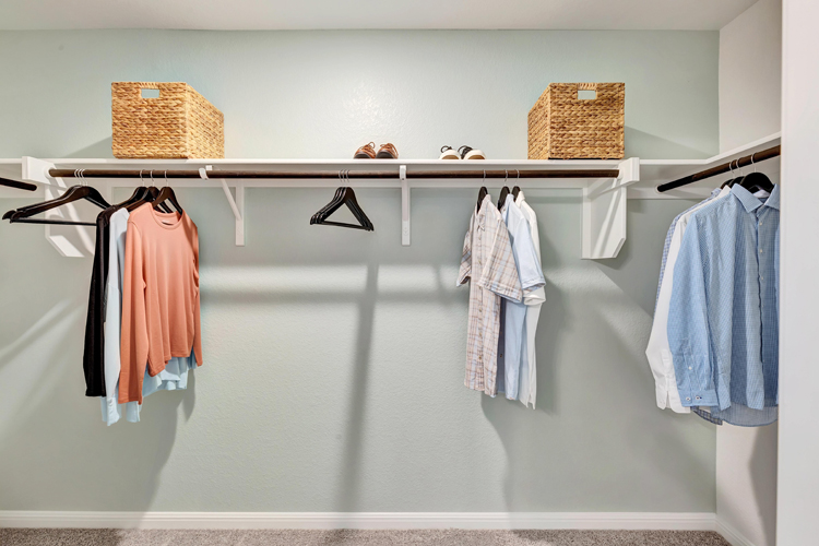 A group of clothes on a rack.