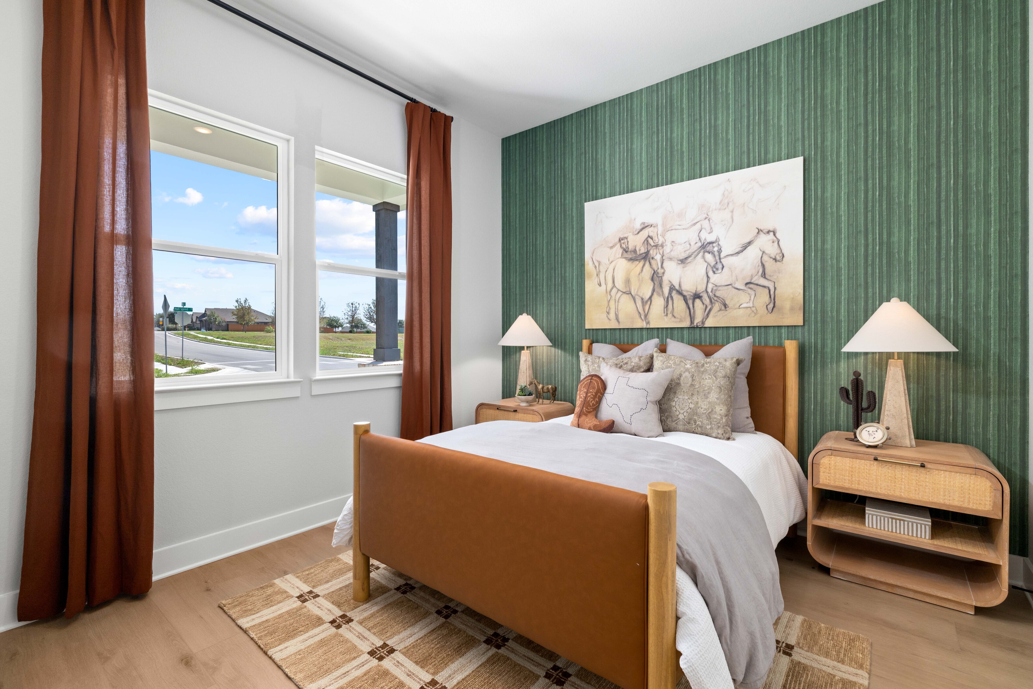A bedroom with a large window.