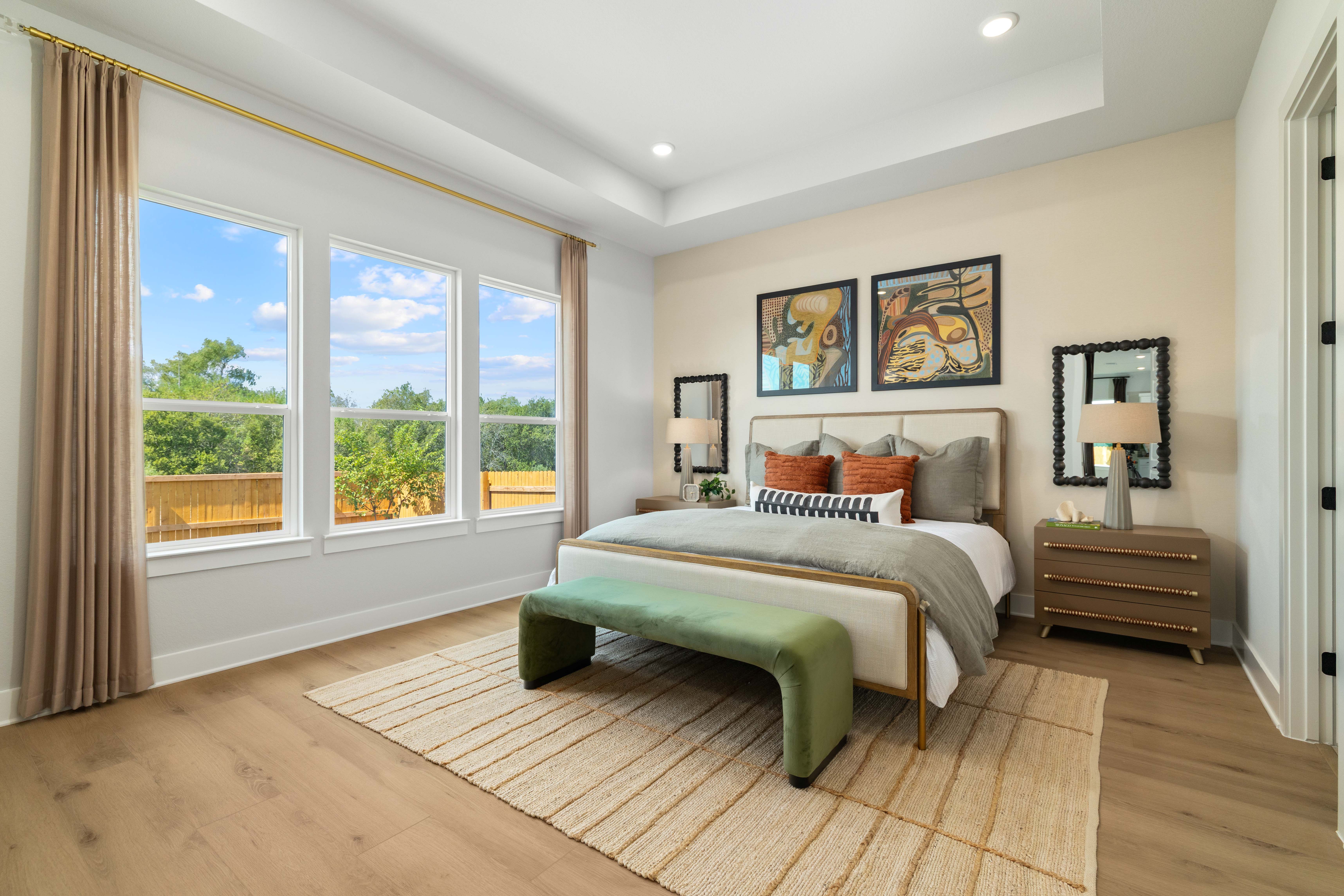 A bedroom with a large window.