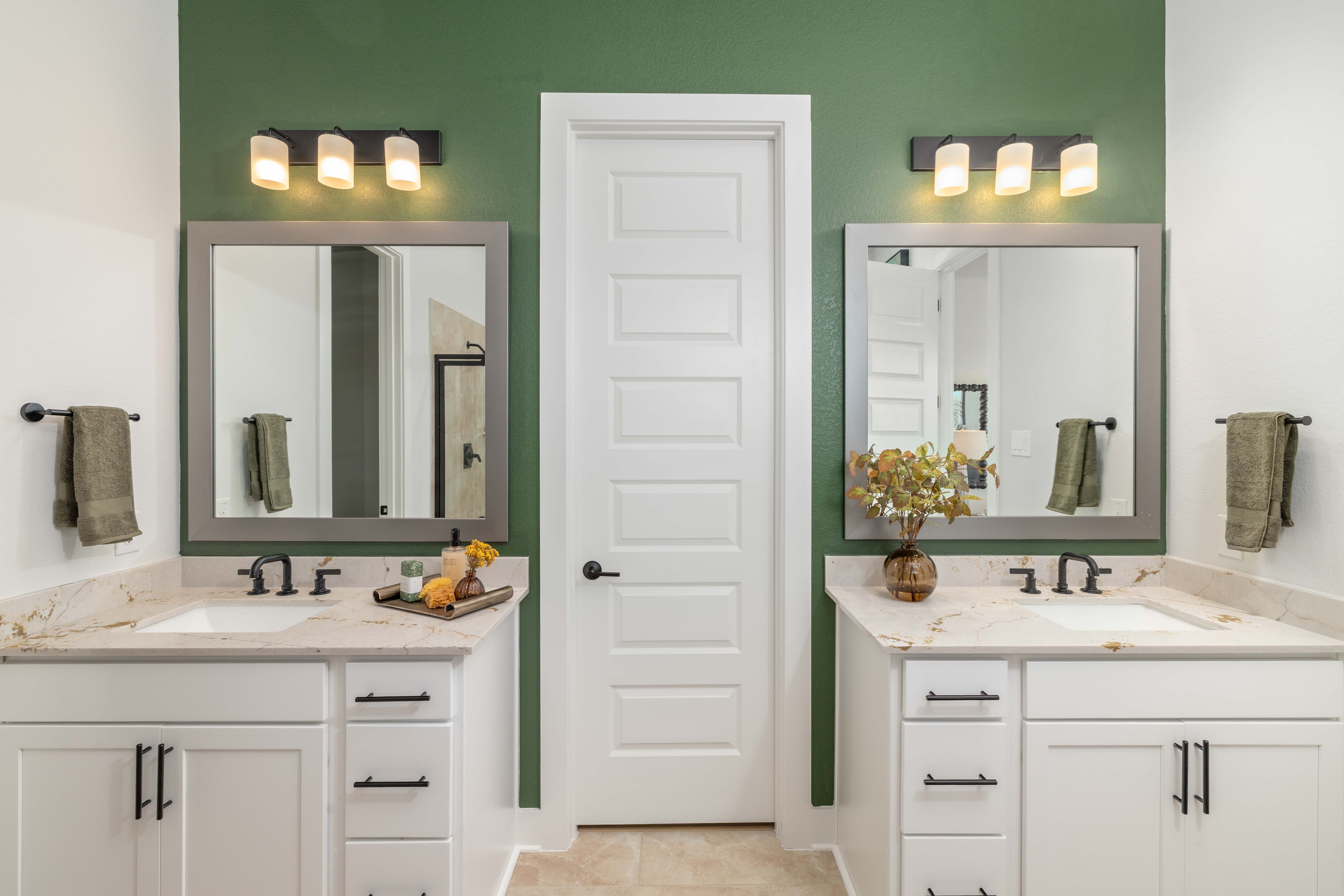 A bathroom with a mirror and sink.