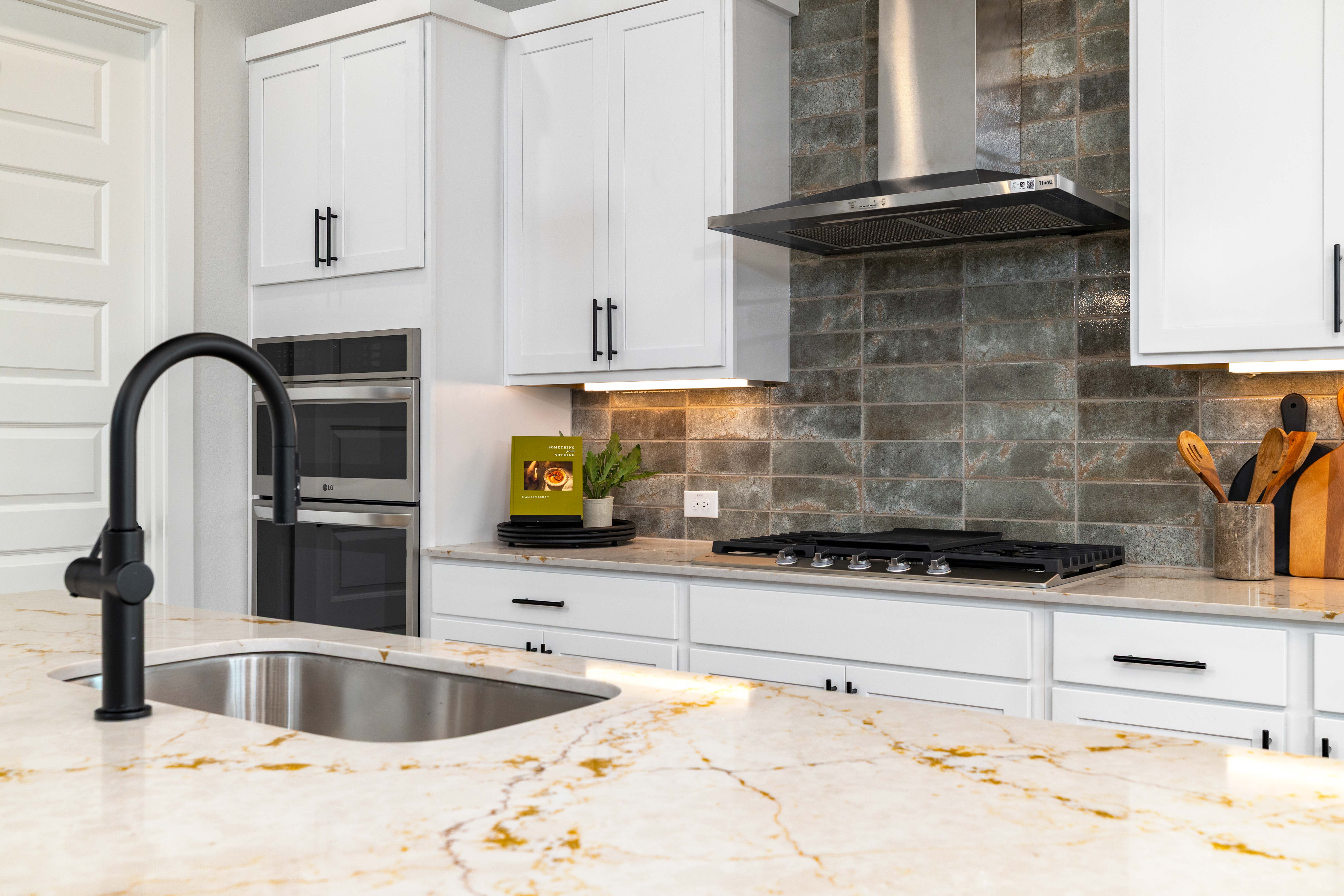 A kitchen with white cabinets.