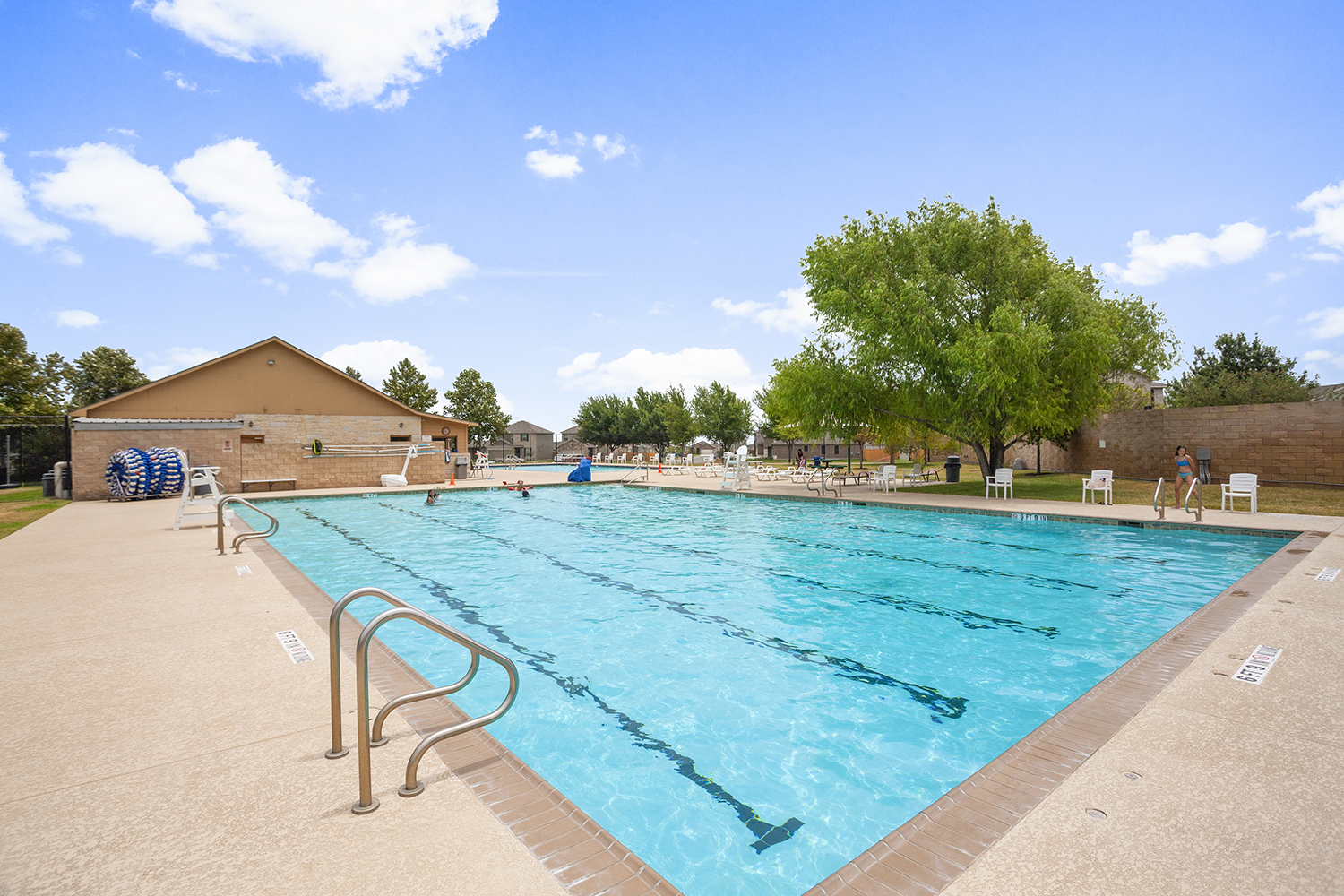 A swimming pool with a building in the background.
