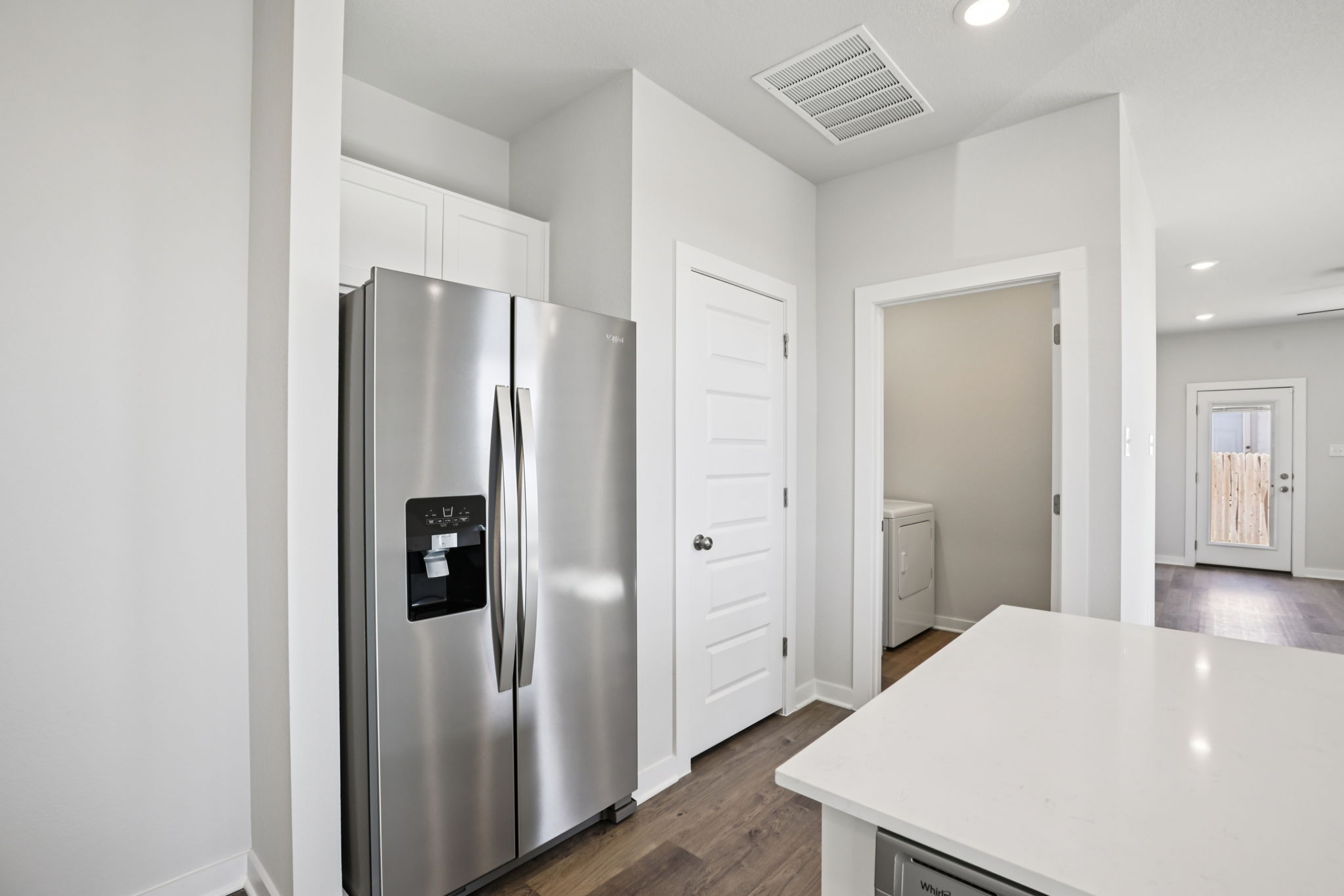 A kitchen with white cabinets.