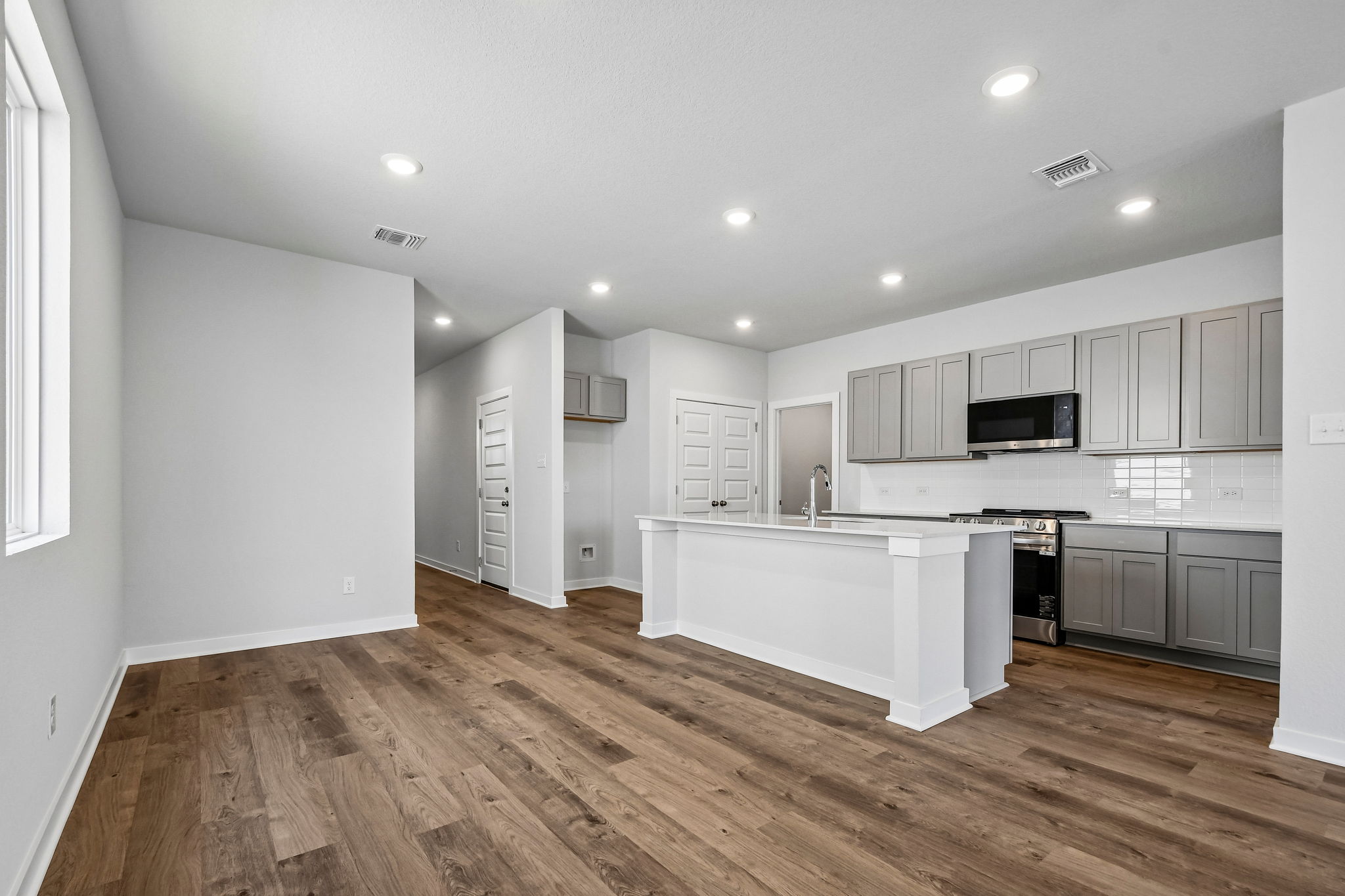A kitchen with white cabinets.