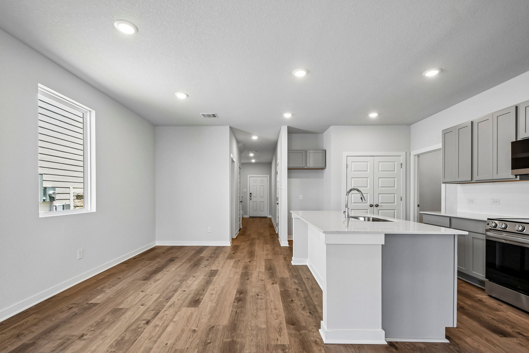 A kitchen with white cabinets.