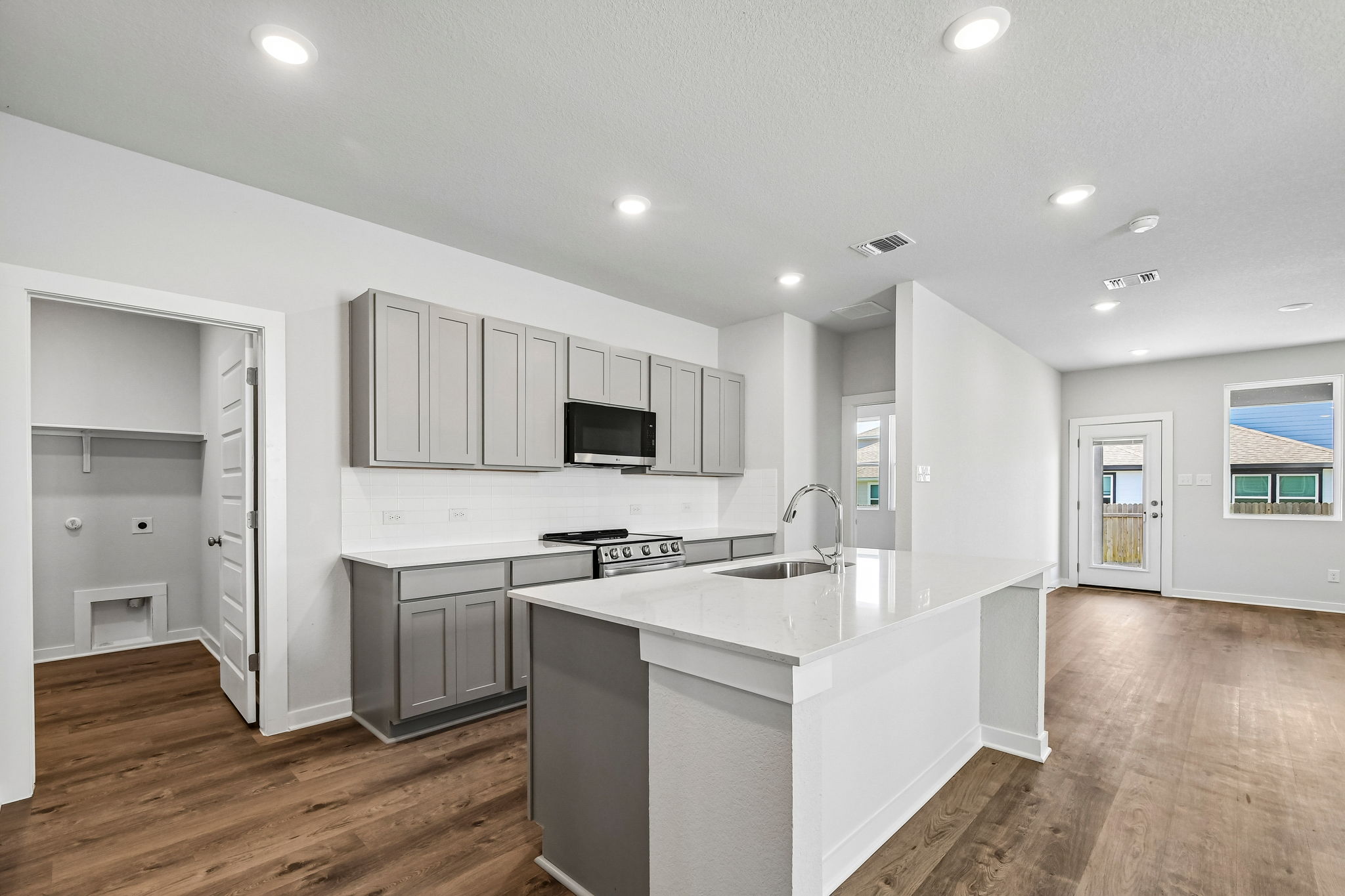 A kitchen with white cabinets.