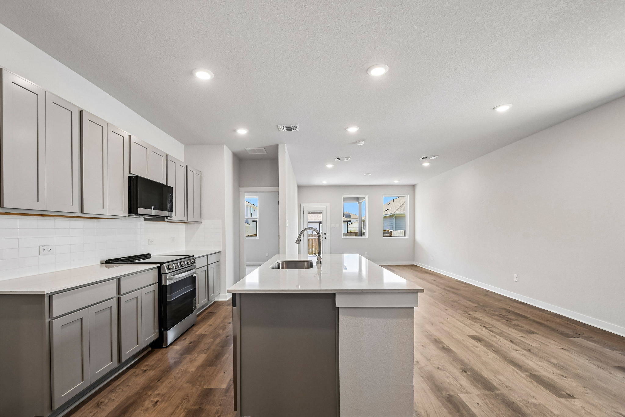A kitchen with white cabinets.