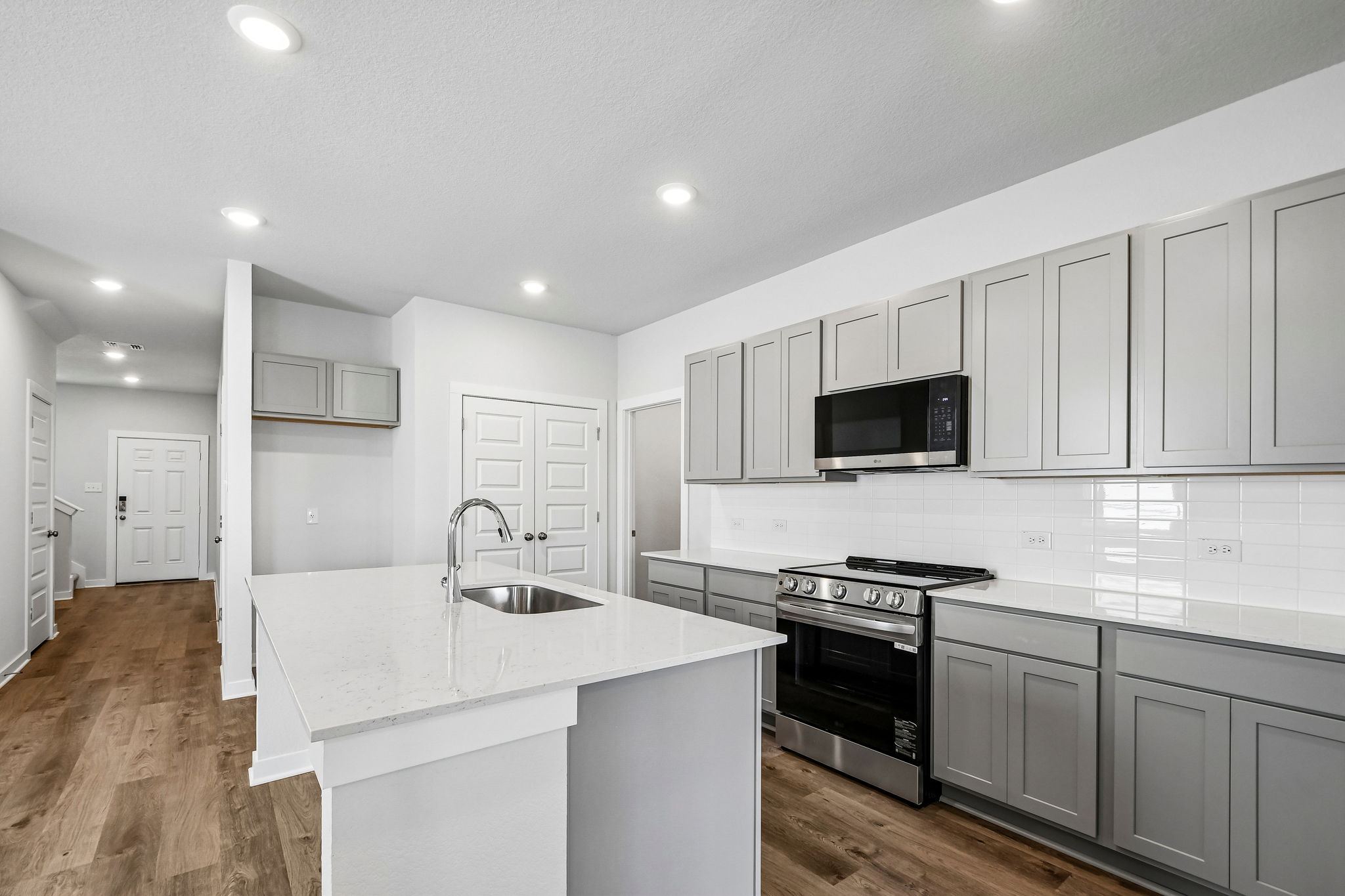 A kitchen with white cabinets.