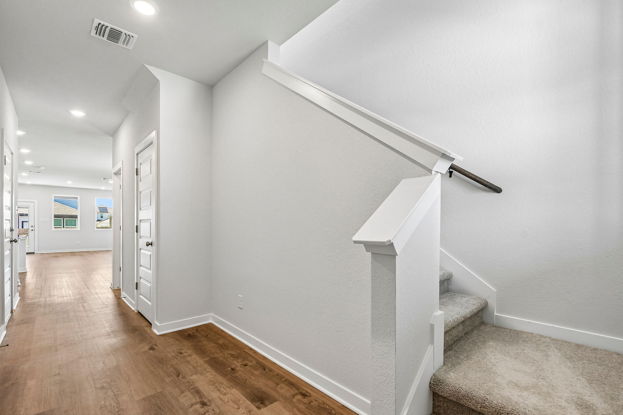 A white staircase in a room.