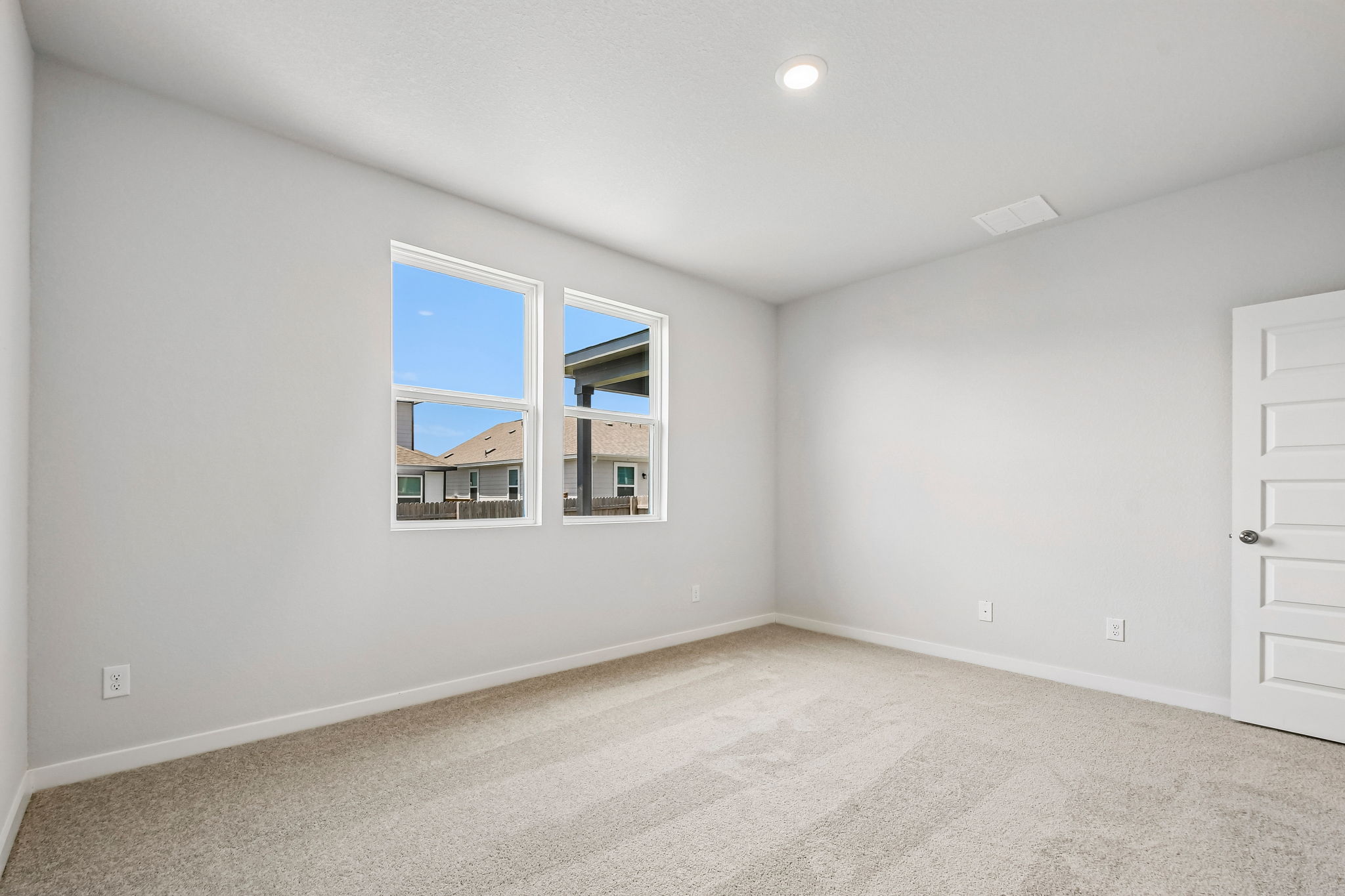 A room with a window and a door.