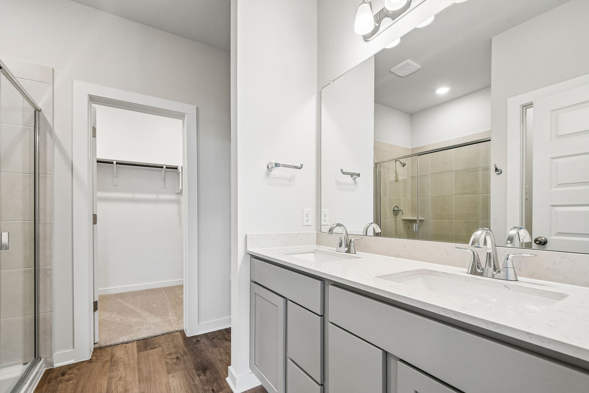 A bathroom with a large mirror.