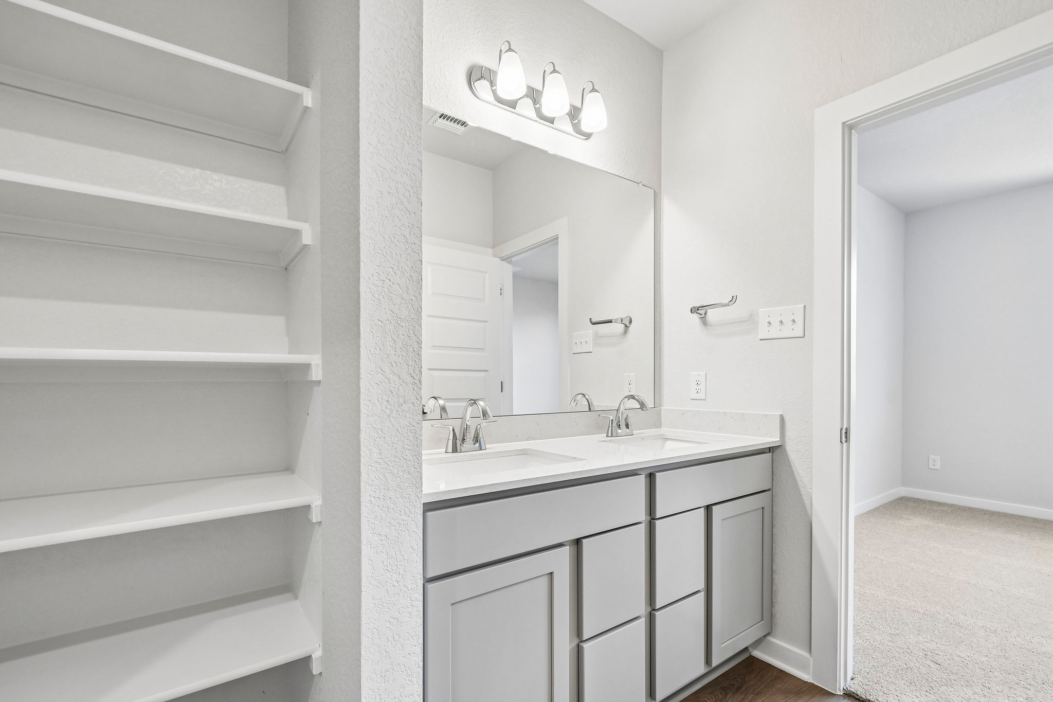 A bathroom with white walls.