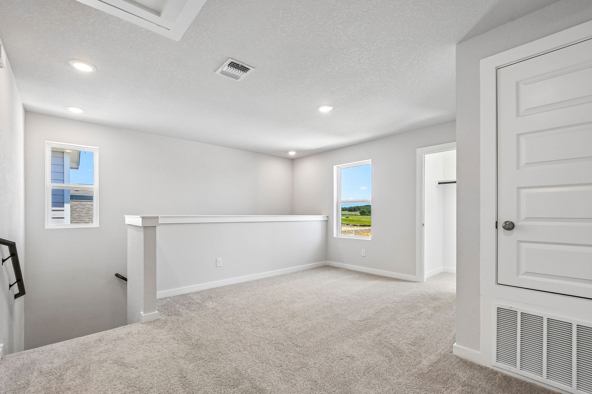 A room with white walls and a white bench.