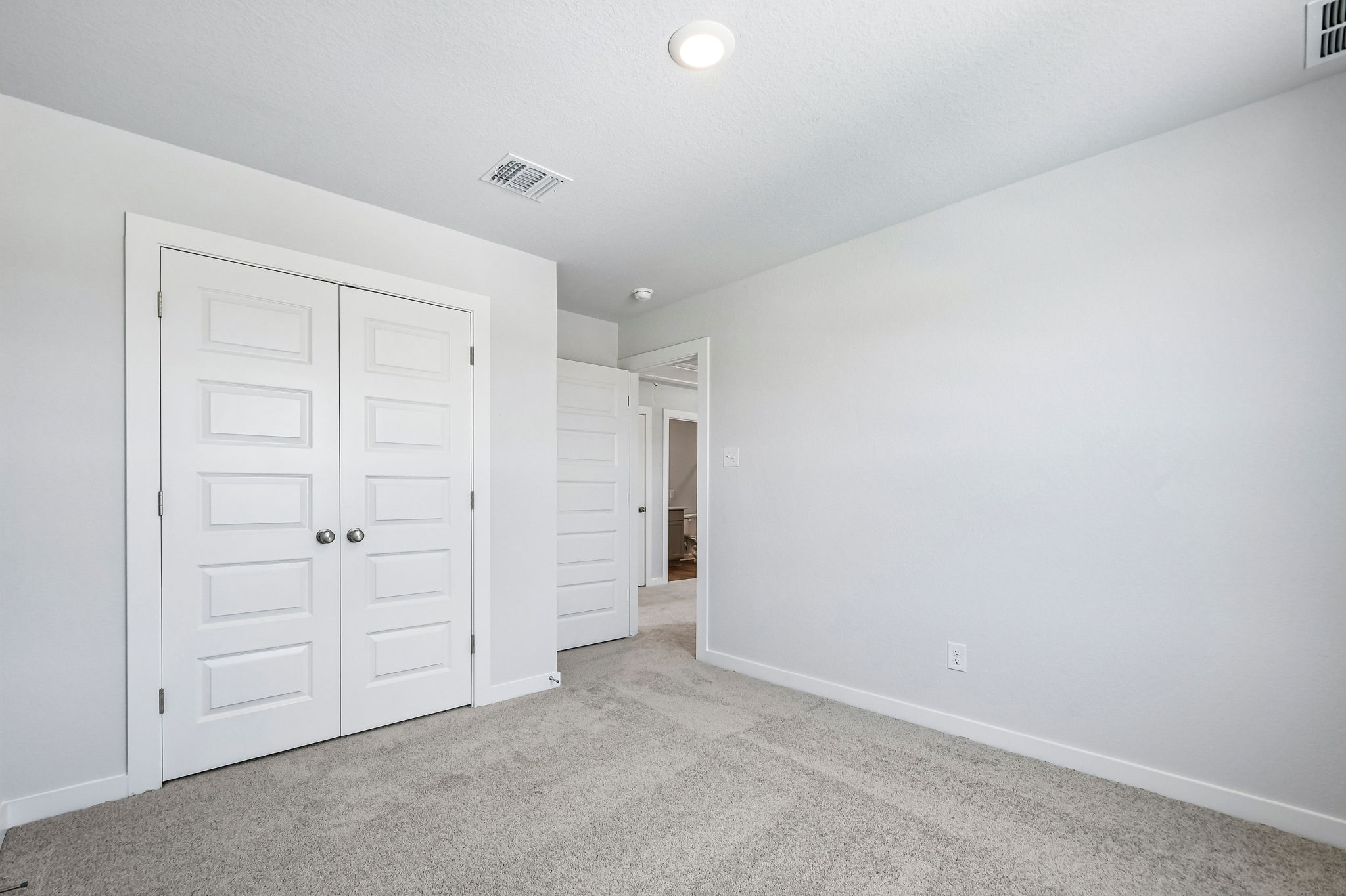 A hallway with white doors.